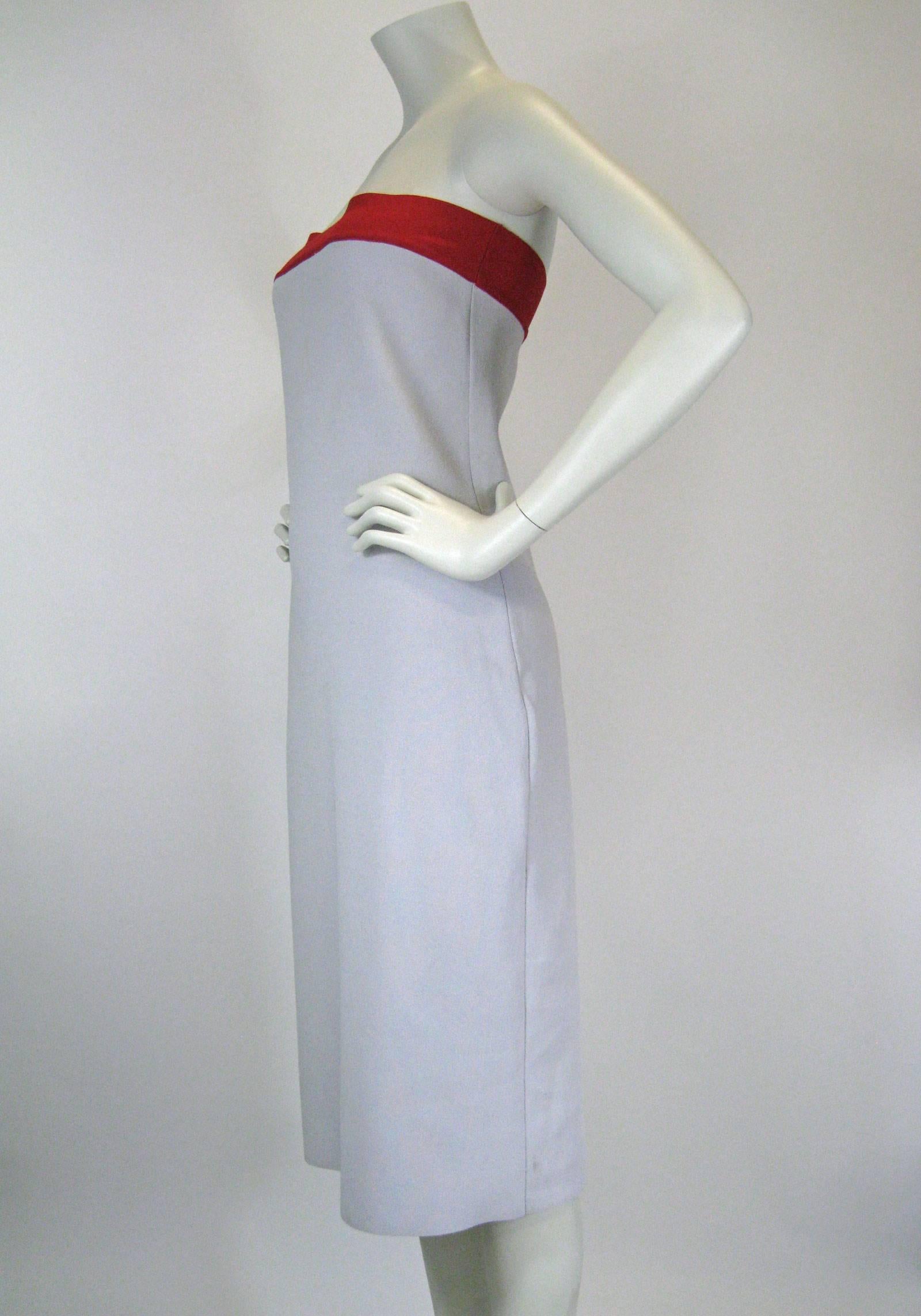 Narciso Rodriguez dress.
Pale gray with red banded chest.
Hourglass shape.
Thicker, stretch blend knit.
Tagged a size US 12.

Measurements taken flat, garment will stretch.
Bust: 30