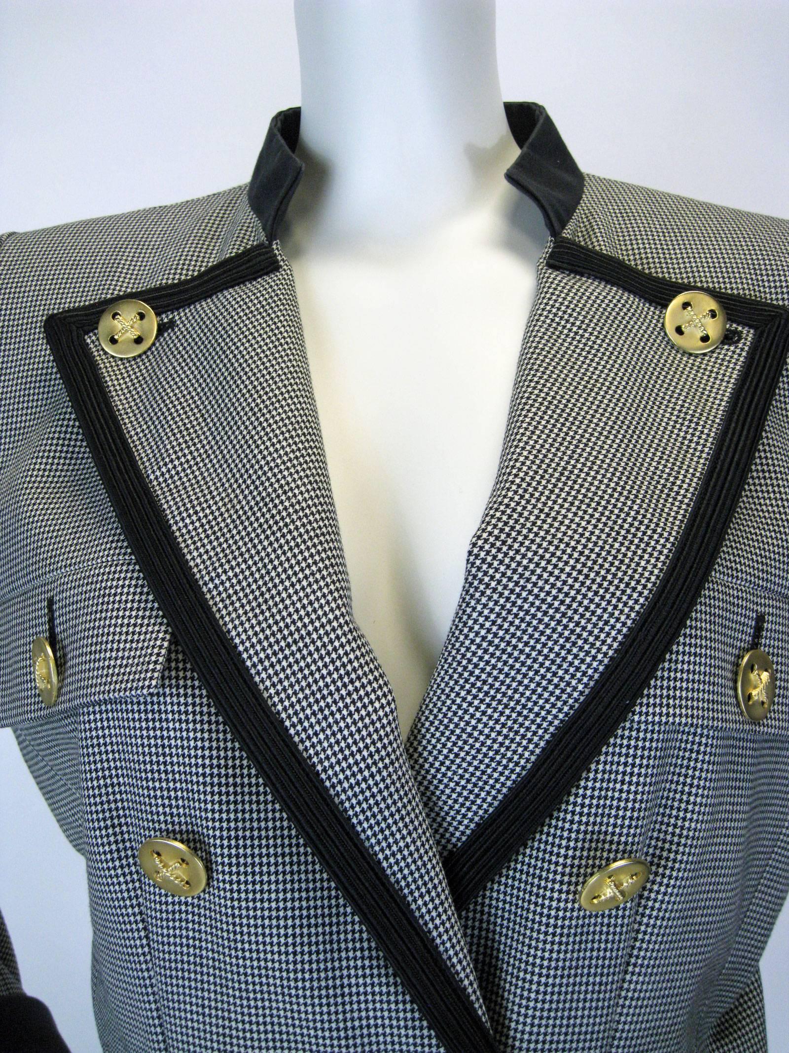 Black and white herringbone YSL Rive Gauche jacket.
Military inspired double breasted with black trim and gold buttons.
Button details on cuffs.
Faux chest and hip pockets.
Fully lined.
Tagged a size 40.

