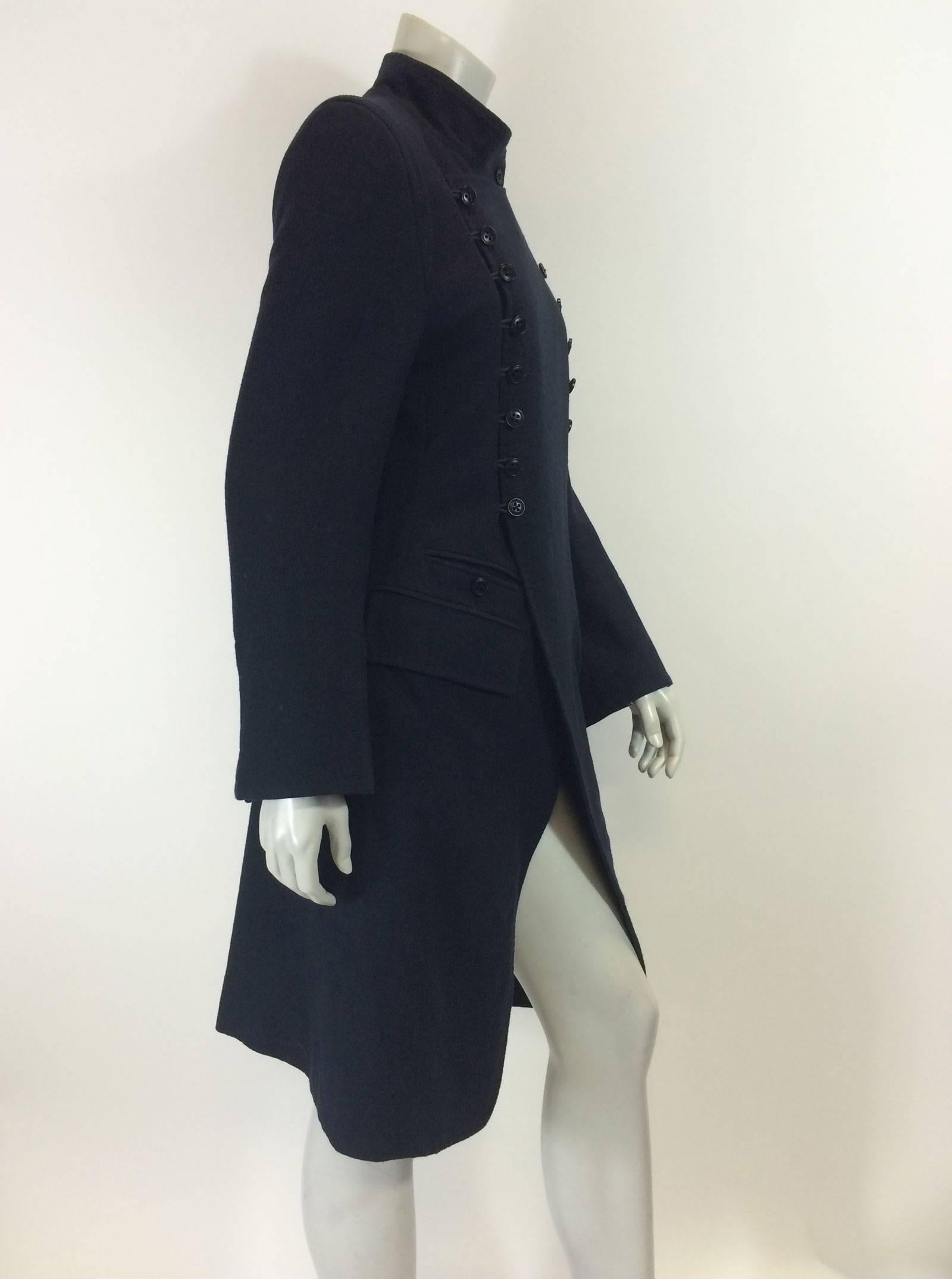 Impeccably designed Ann Demeulemeester coat.
Military inspired.
Dark navy blue (almost black) cotton/wool/cashmere blend.
HIgh neck with button closure.
Double breasted, can button left or right. 
Two rows of buttons, button holes and elastic