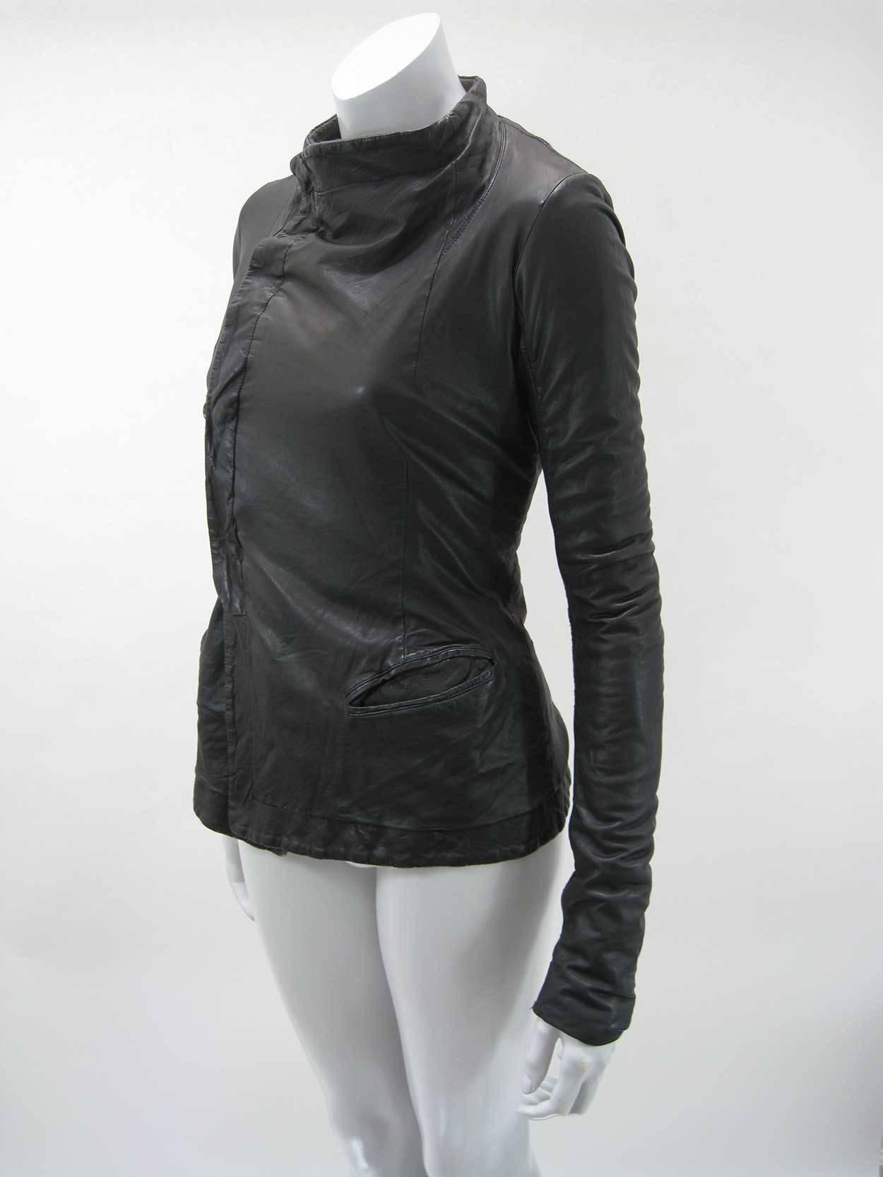 Rick Owens fitted leather jacket.

Very soft lambskin leather with intentional wrinkled/distressed look.

Hidden button closure.

Body is lined in fleece-like fabric.

Arms feature ribbed knit arm-length panels.

Front pockets and inside