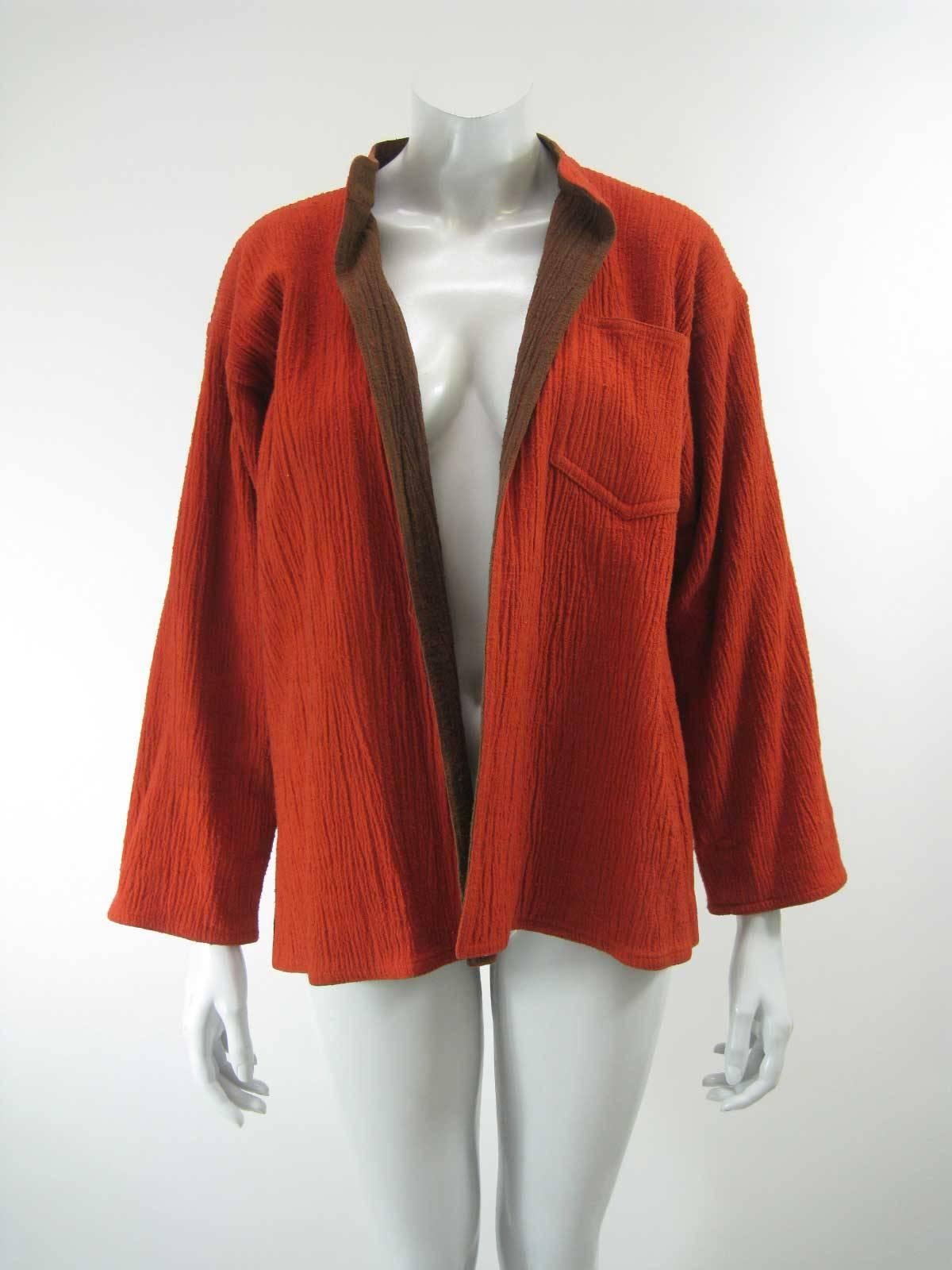 Very early vintage Issey Miyake jacket.

Contrasting colors of orange and brown.

Can be worn cuffed or not.

Large chest pocket.

Loose, Japanese style open shape with no closures.

Upright collar.

Cotton crinkled fabric. 

This item is in good