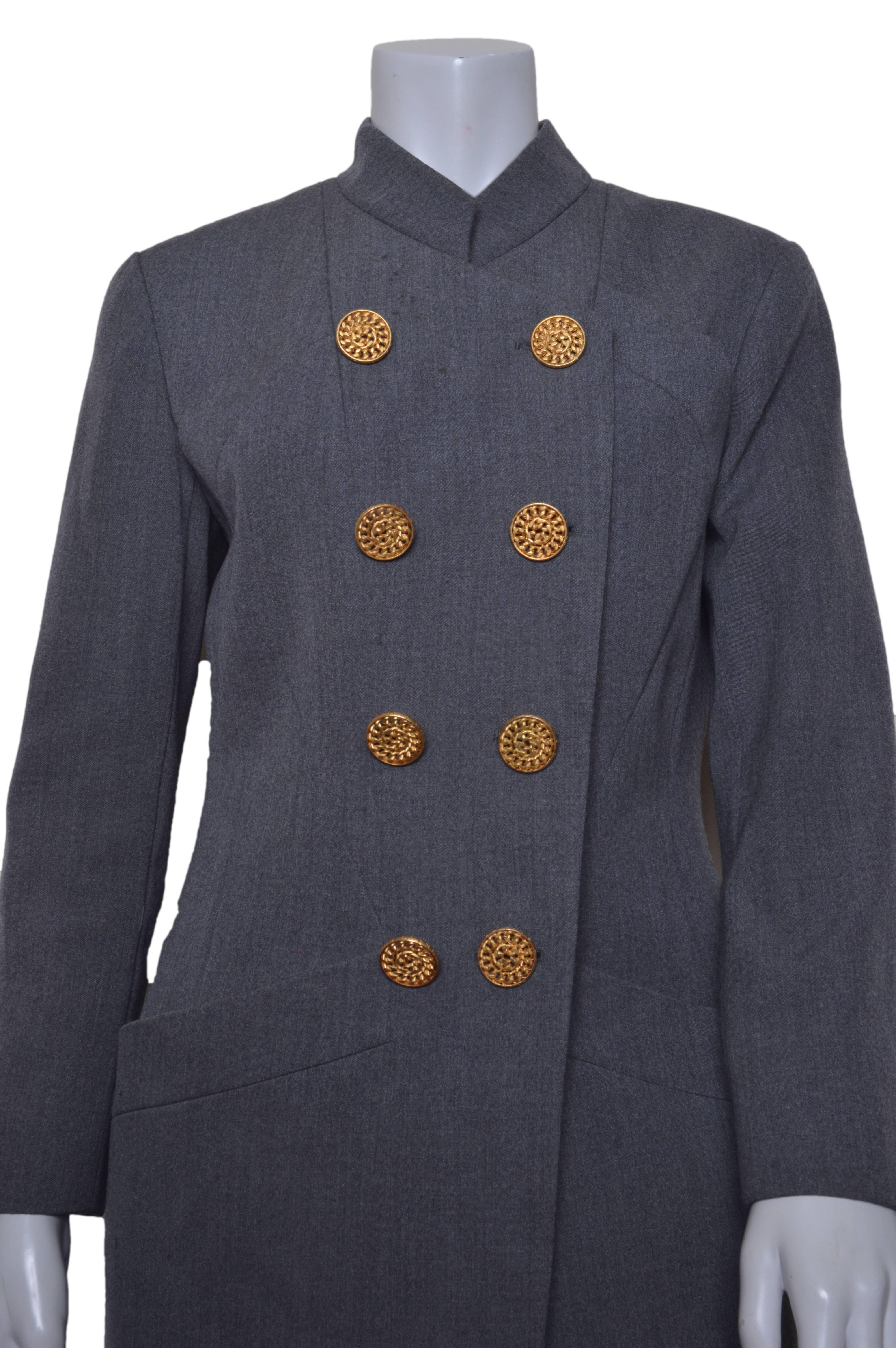 Vintage Chanel Boutique gray wool suit. 
As stated on handwritten tag:
Collection: 29
Style: 20634

Double breasted jacket features oversized gold buttons.
Three button cuff detail.
Slanted chest pockets.
Large bucket pockets on hip.
The