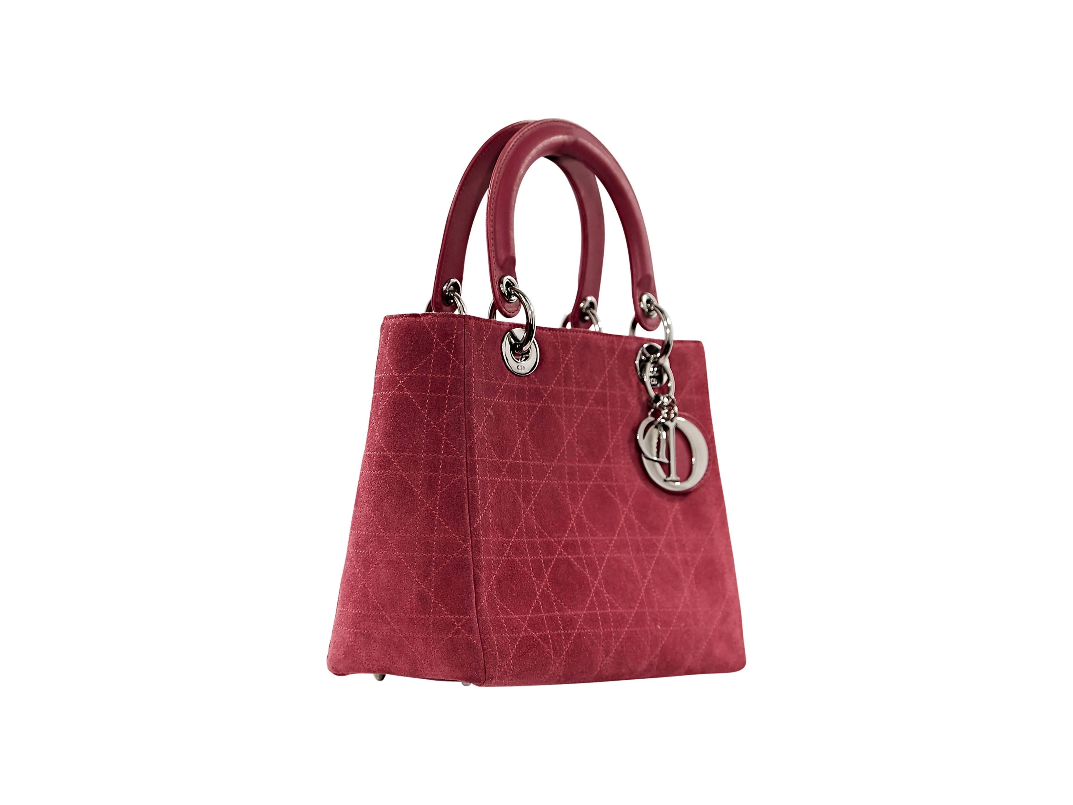 Iconic Lady Dior suede bag by Christian Dior. Top carry handles.  Removable shoulder strap.  Protective metal feet.  Silvertone hardware.