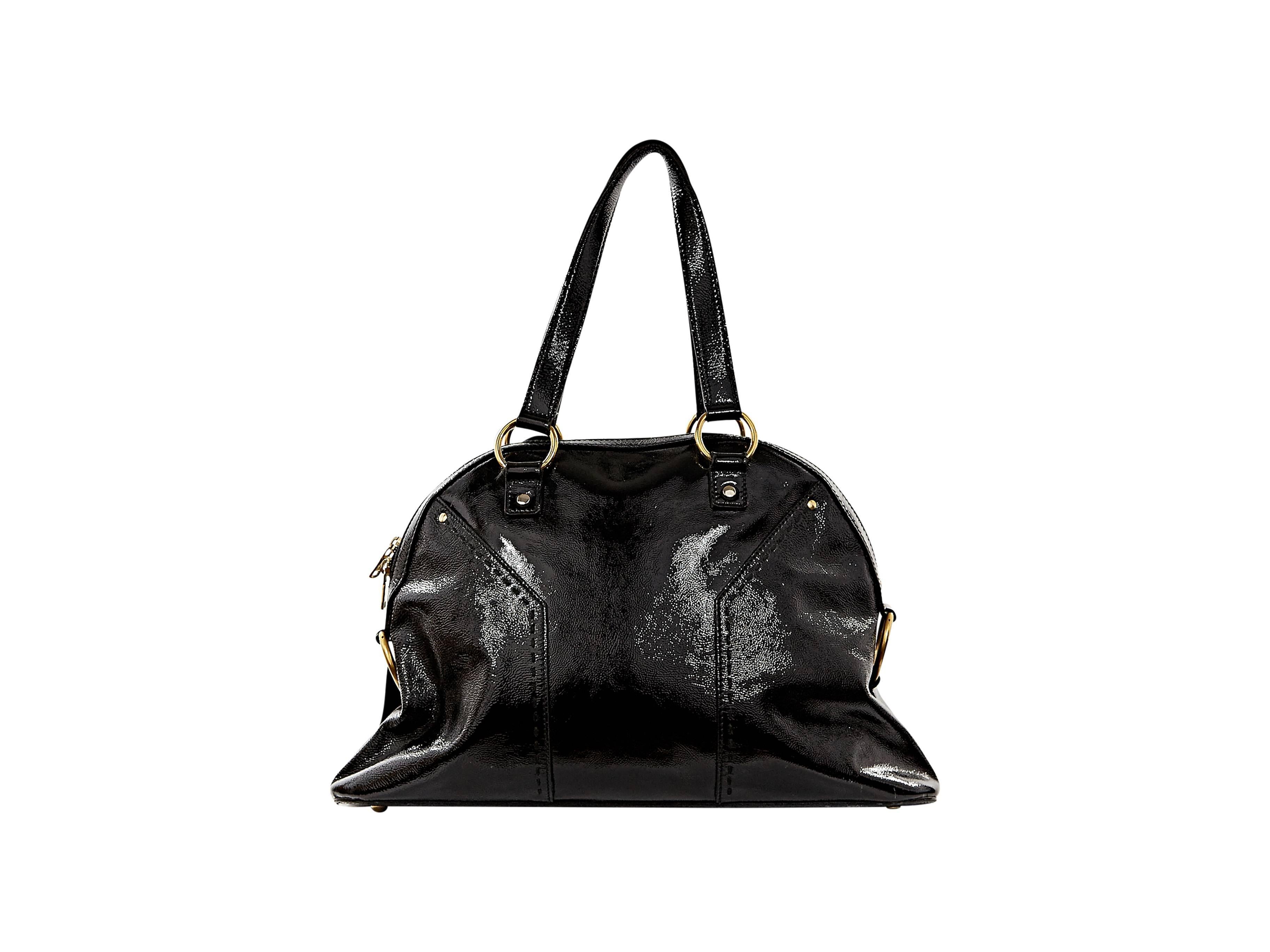 Iconic Muse dome tote bag by Yves Saint Laurent.  Crafted from black patent leather.  Double carry handles.  Top zip closure.  Protective metal feet.  Goldtone hardware.