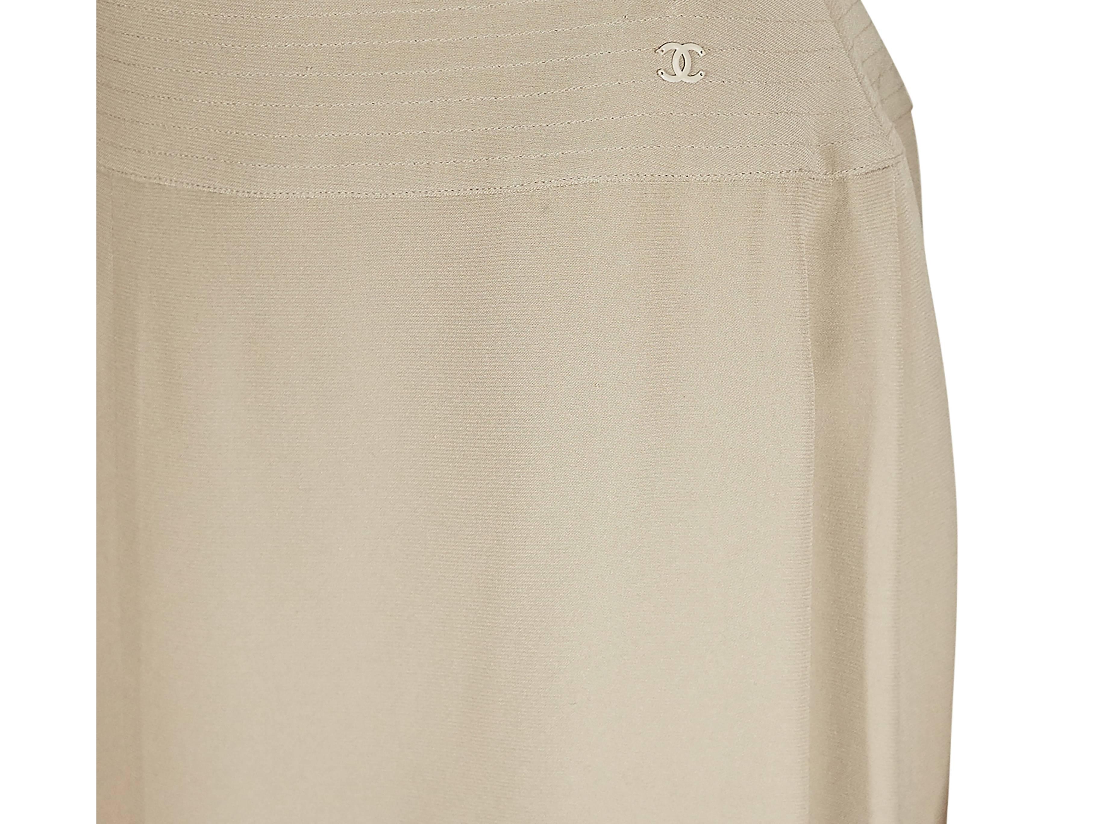 Tan silk A-line skirt by Chanel.  Banded waist with tonal topstitching.  Concealed back zip closure. 