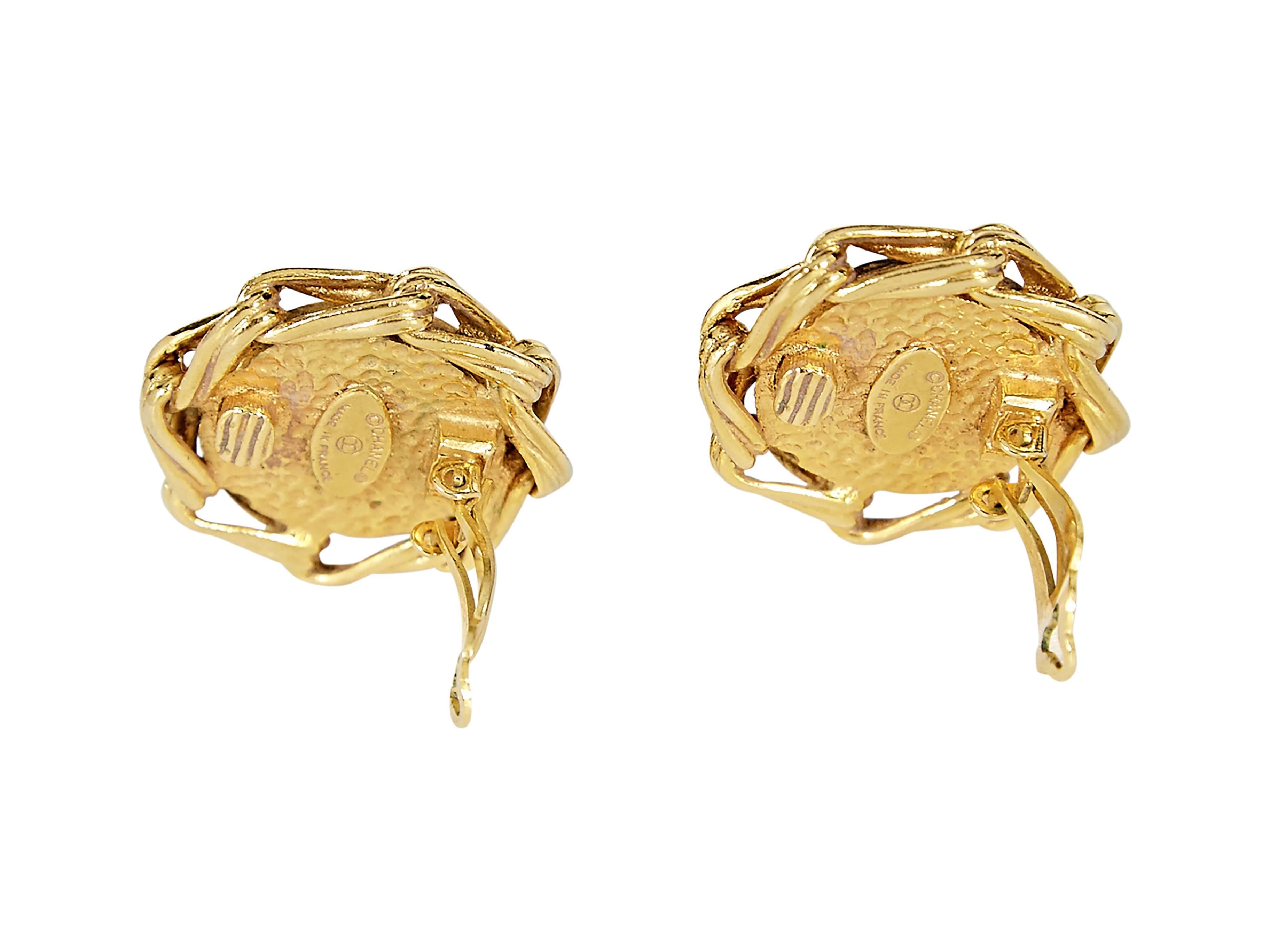 Round goldtone clip-on earrings by Chanel.  Features a pearl center. 1.5