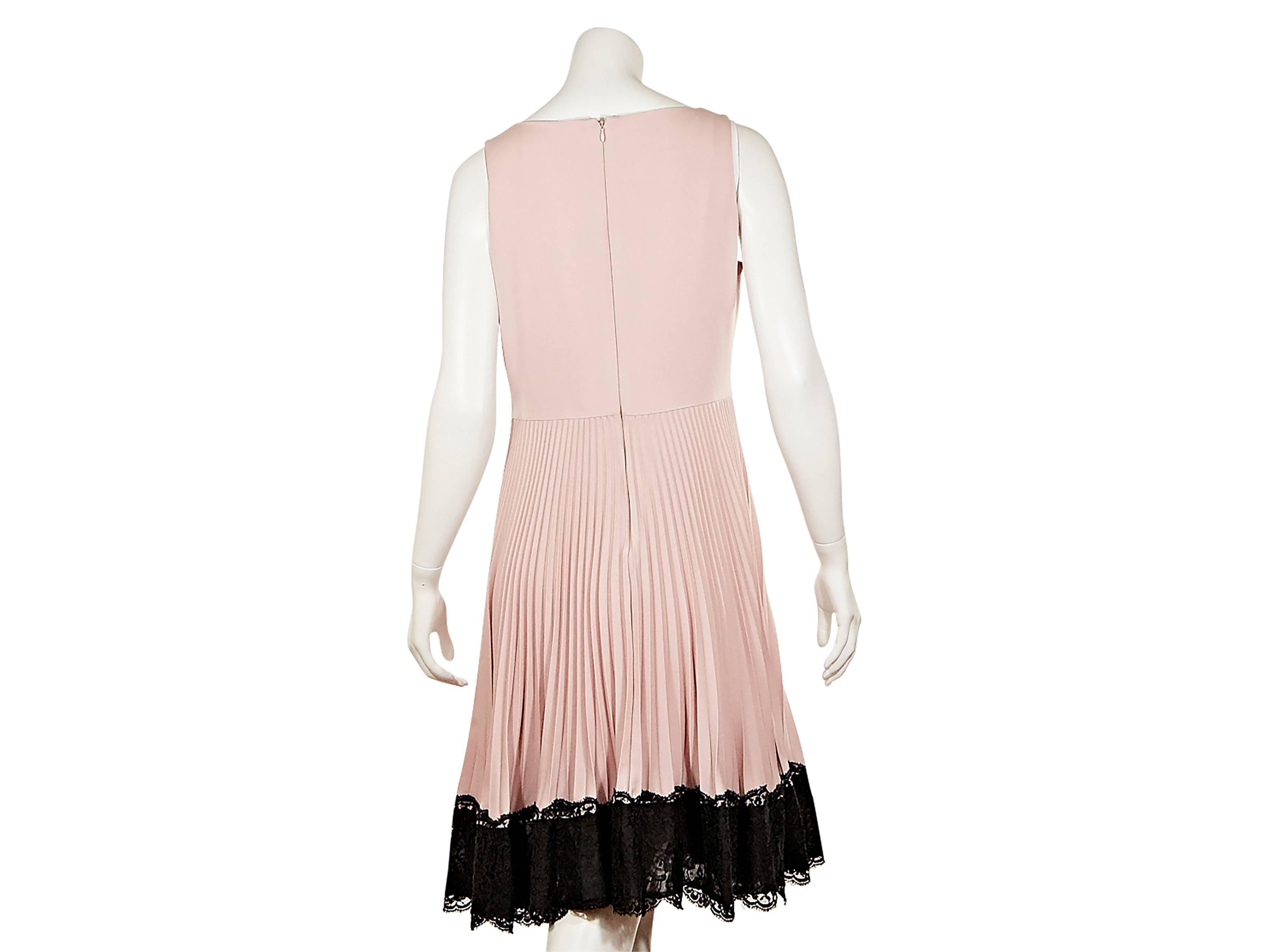 Pink Techno Couture sleeveless dress by Valentino.  Bateau neckline.  Pleated skirting with black lace hem. Concealed back zip closure. 