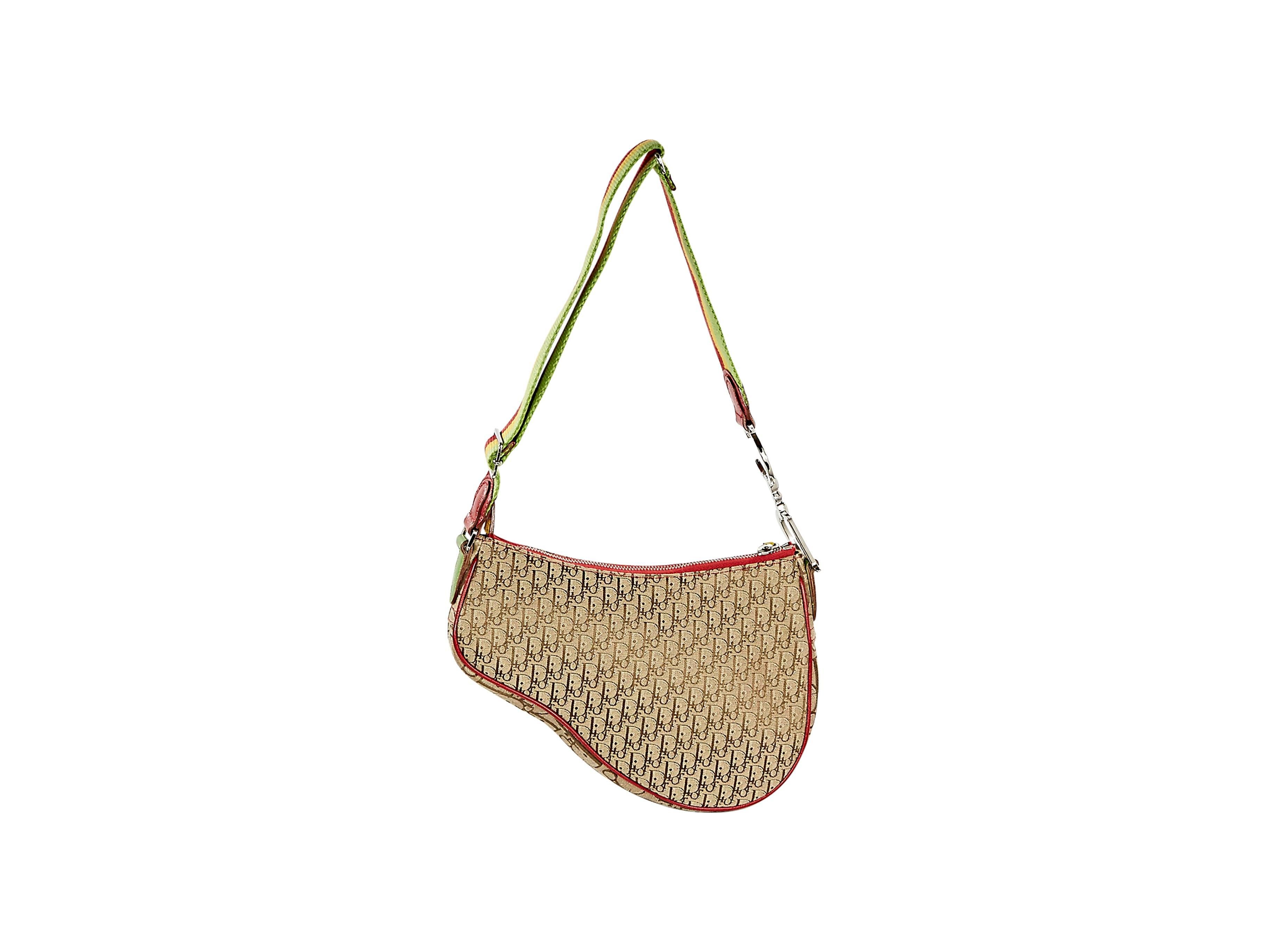 Woven monogram saddle bag by Christian Dior.  Adjustable single shoulder strap.  Hanging 'D' charm.  Top zip closure.  Red, yellow and green trim.  Silvertone hardware. 