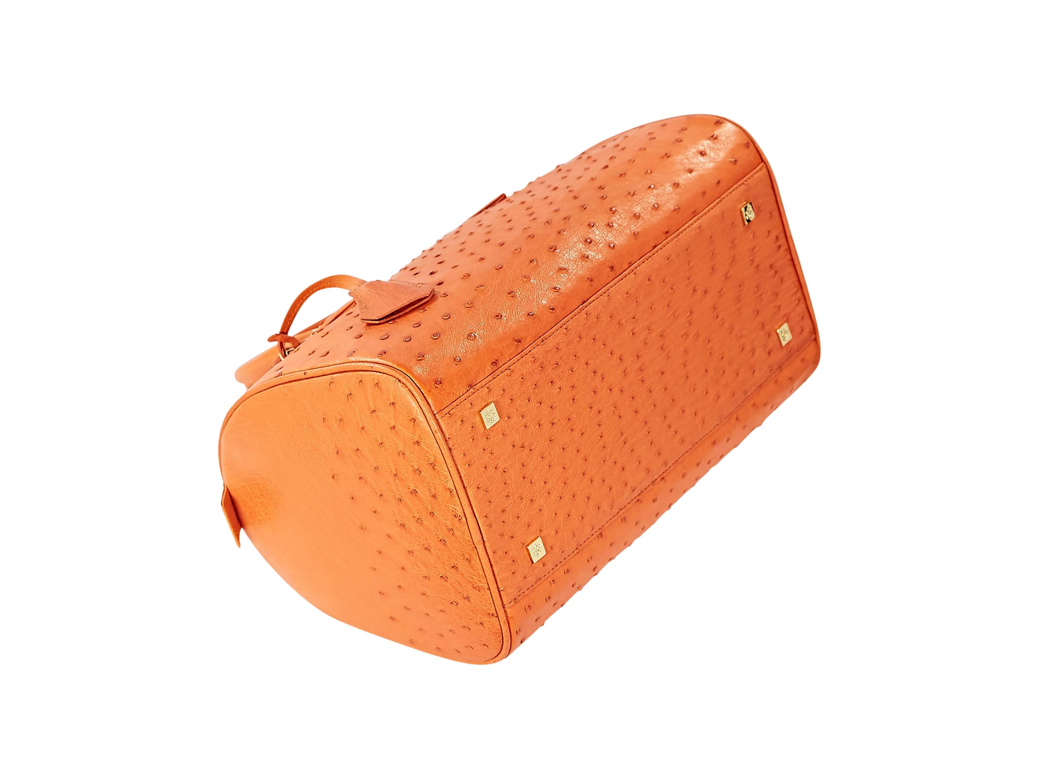 Orange ostrich barrel bag by Brook Brothers.  Dual carry handles.  Top zip closure with lock and key.  Lined interior with zip-close and slide pockets.  Protective metal feet.  Goldtone hardware.  