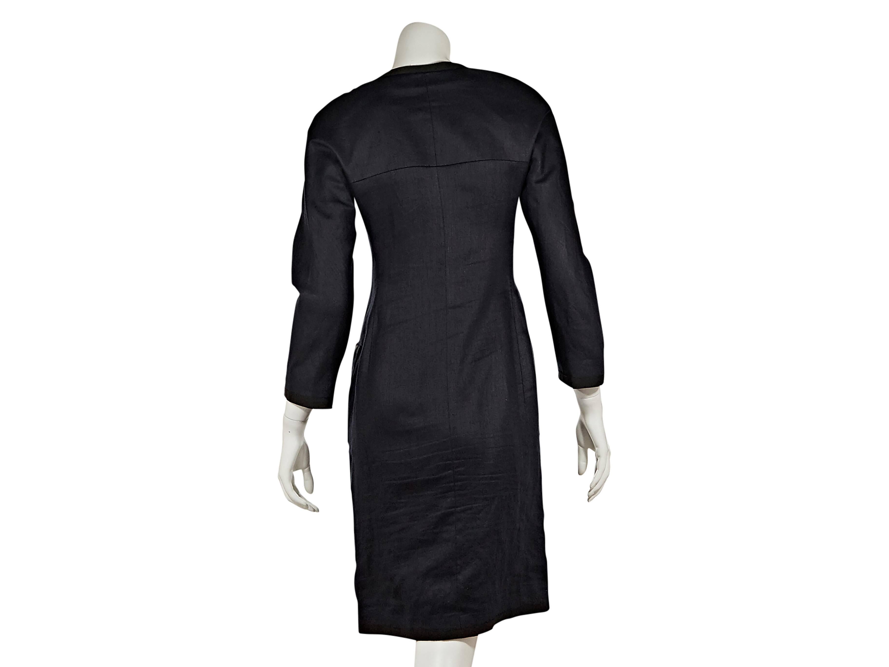 Black linen button-front dress by Chanel.  Jewelneck.  Three-quarter length sleeves.  Goldtone buttons.  Four front patch pockets.