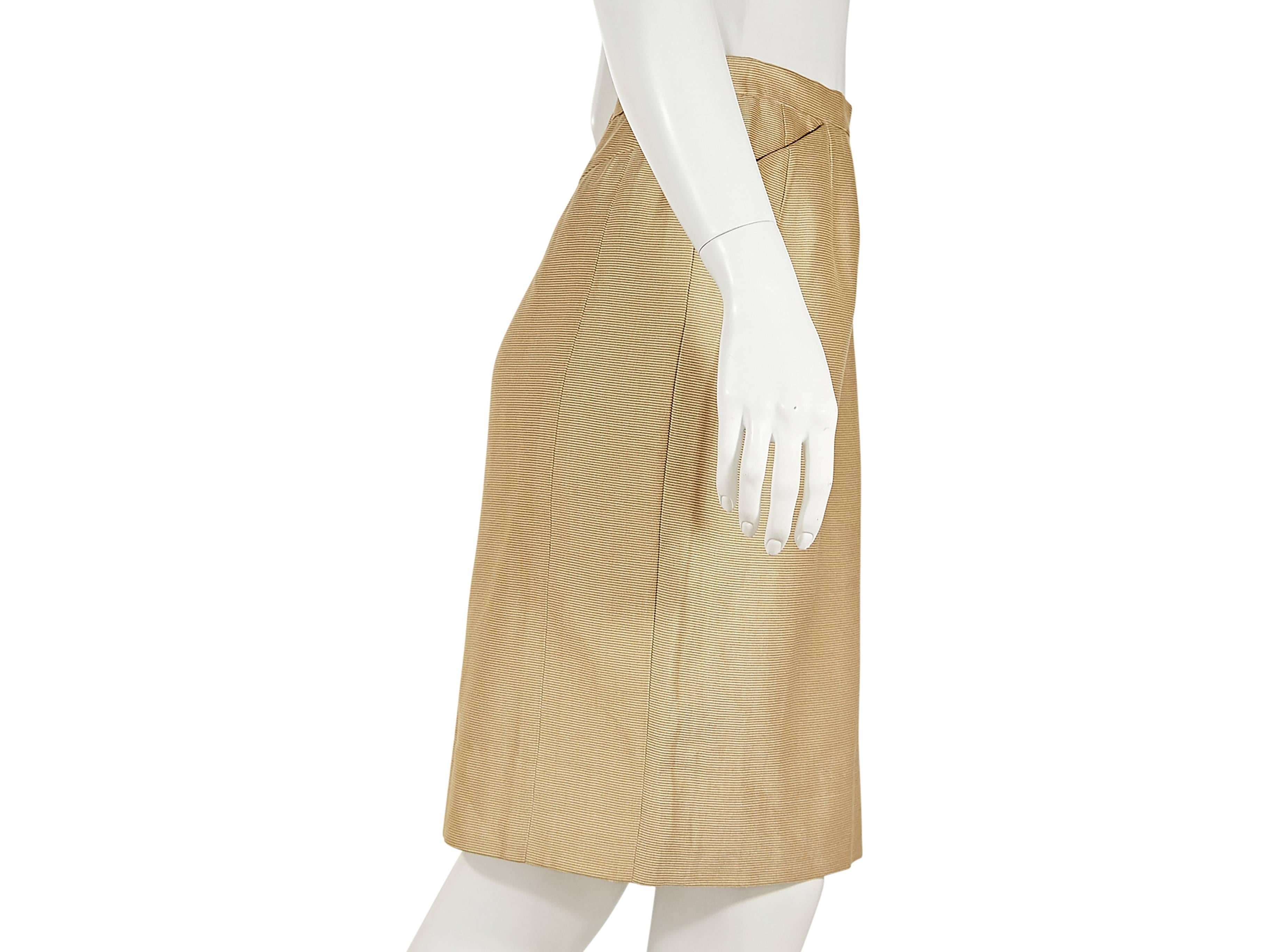Gold silk pencil skirt by Hermes.  Banded waist.  Front slash pockets.  Concealed back zip and button closure.  