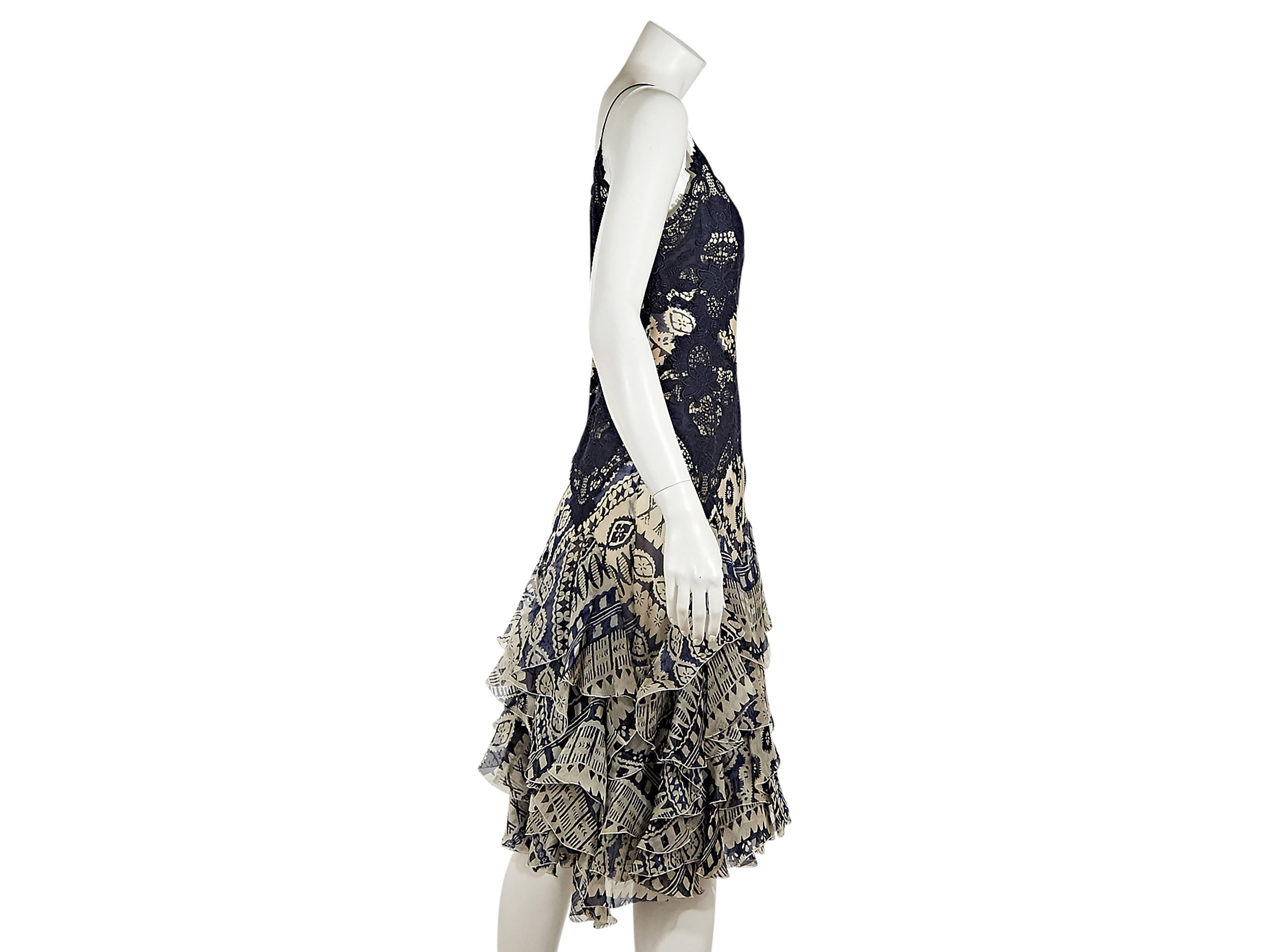 Blue and white printed silk dress by Alexander McQueen.  Lace accents.  Double scoopneck.  Sleeveless.  Concealed back zip closure.  Tiered ruffle hem.  