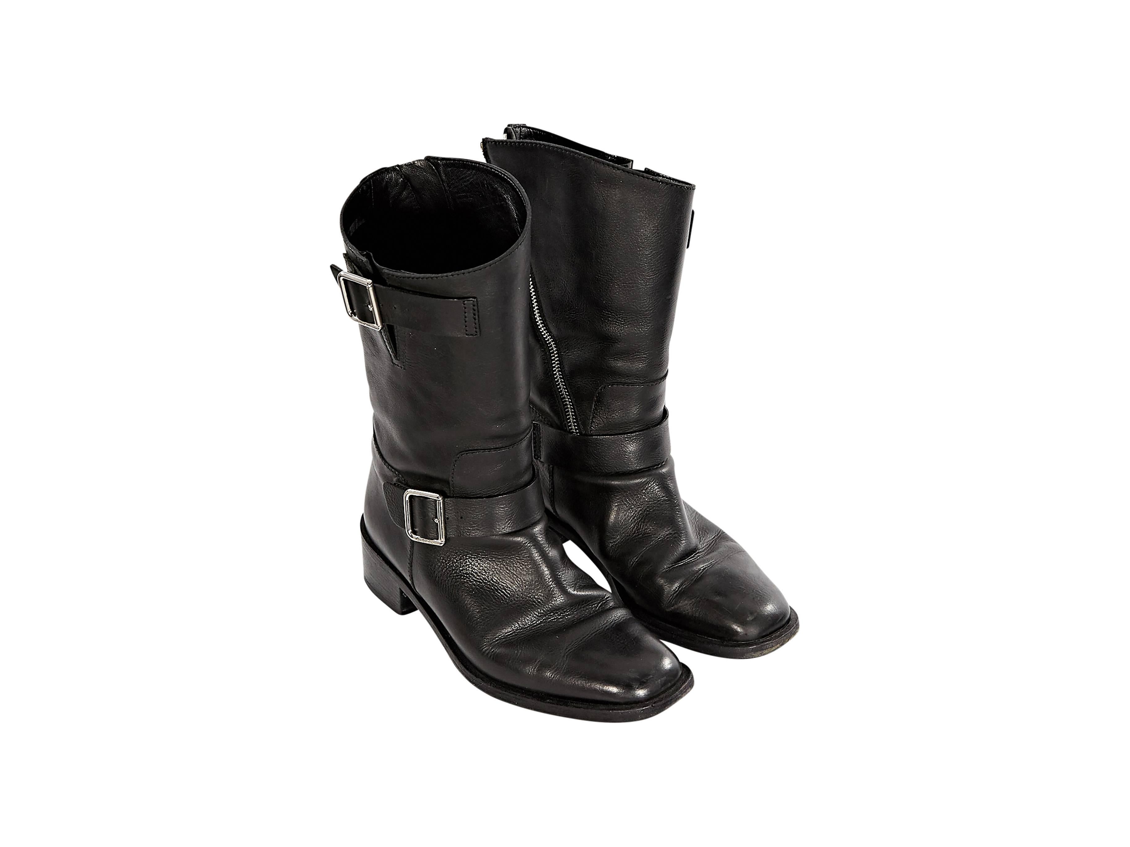 Black leather moto-style boots by Chanel.  Accented with two buckle straps.  Inner diagonal zip closure.  Rounded square toe.  Stacked heel.  Silvertone hardware.  