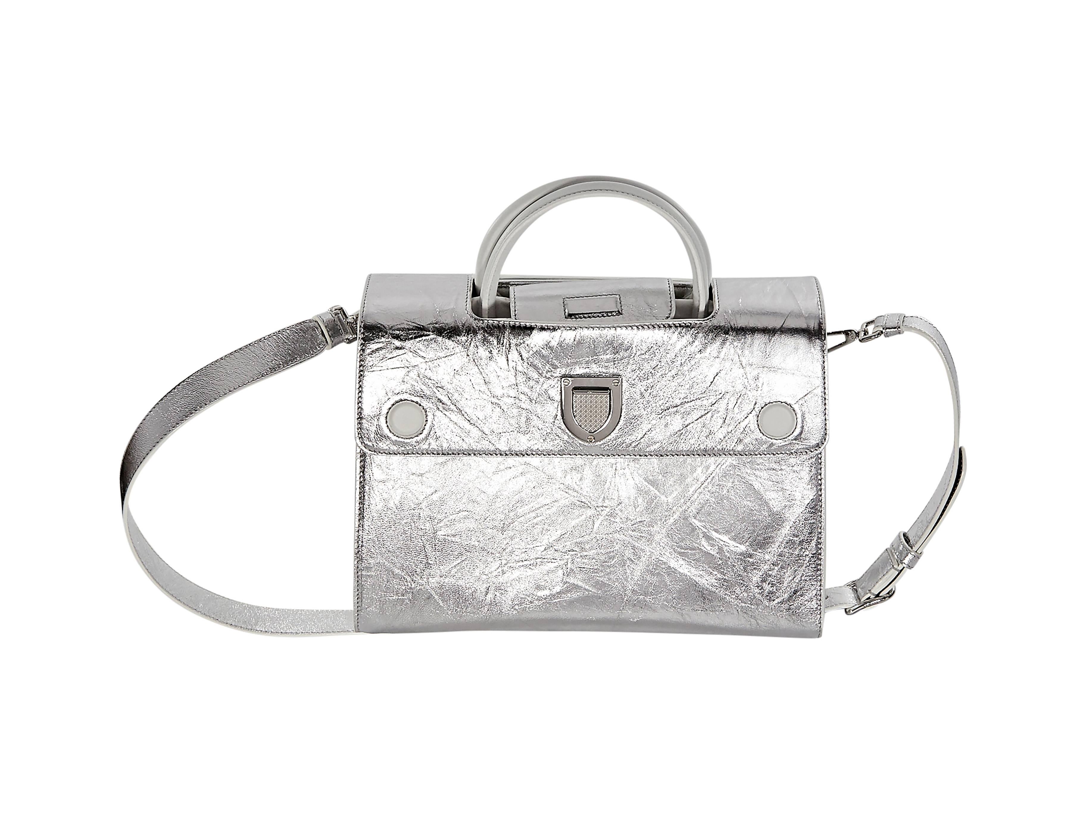 Medium Silver leather Diorever satchel by Christian Dior.  Top handle.  Detachable, adjustable crossbody strap.  Front flap with push-lock closure.  Inner pockets.  Protective metal feet.  Silvertone hardware. 