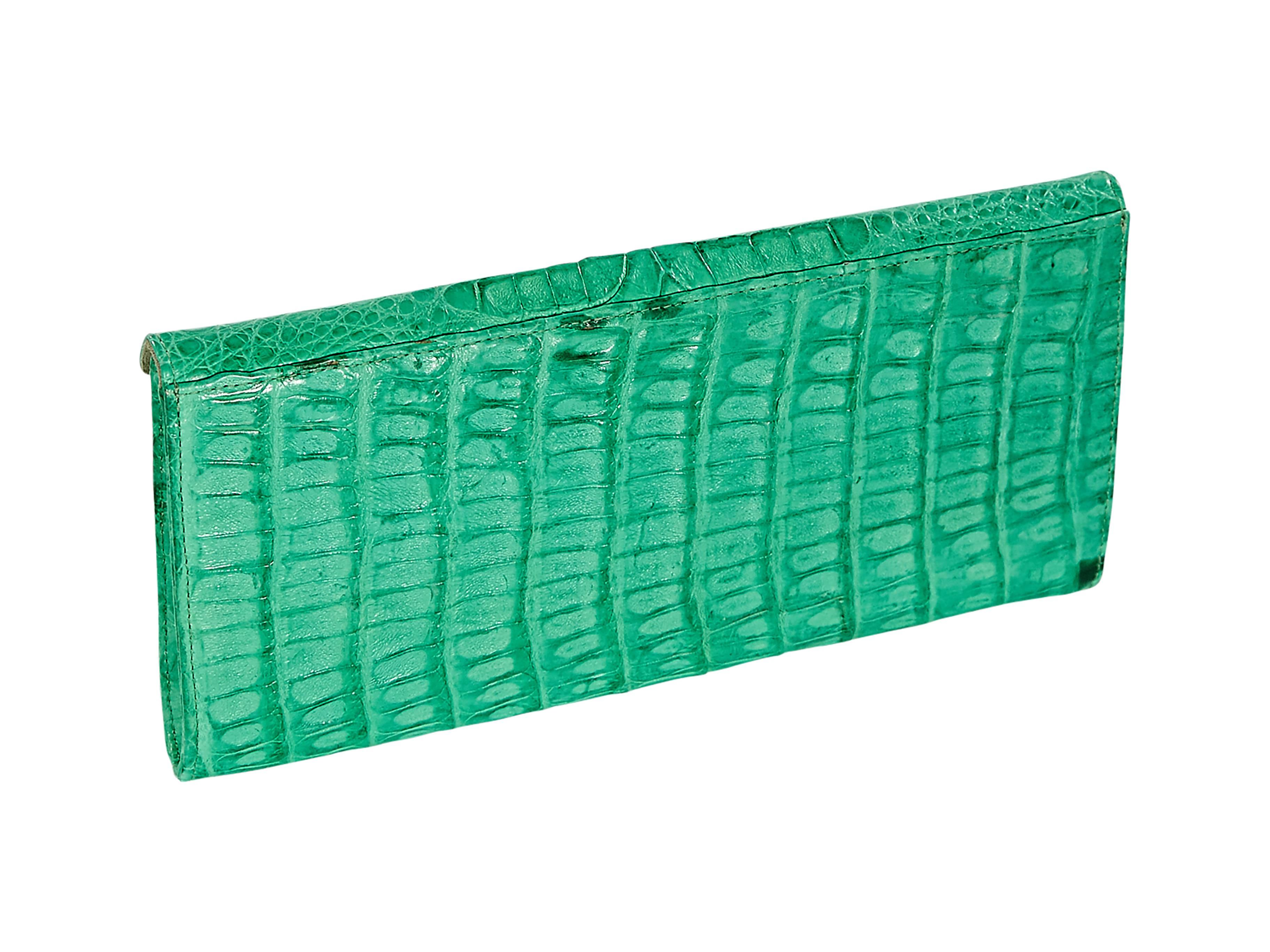  Green crocodile clutch by LAI.  Front flap with hidden magnetic closure.  Lined interior with zip pocket.  