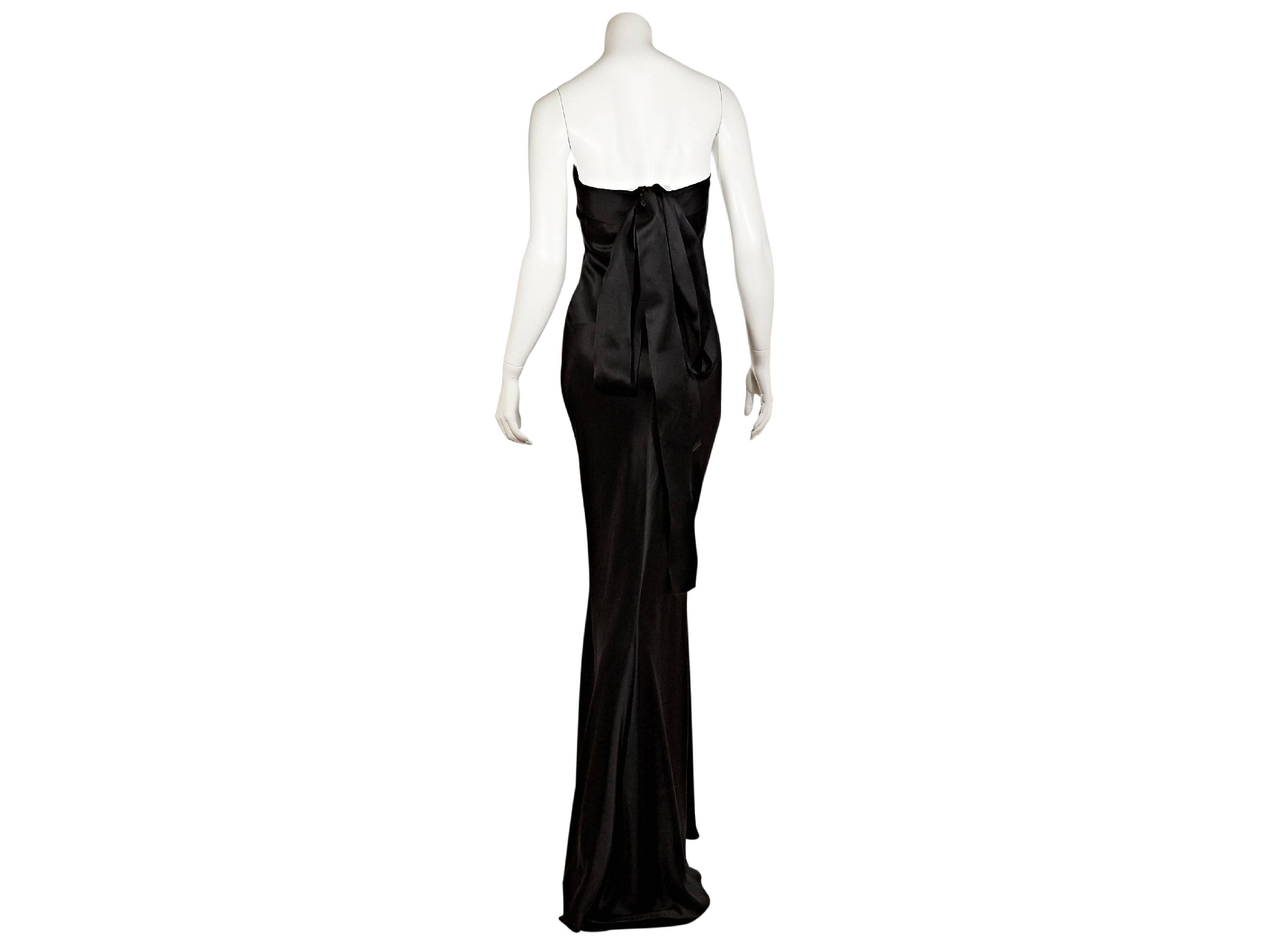 Black strapless satin gown by J. Mendel.  Banded topline.  Seam work creates a flattering silhouette.  Oversized back bow.  