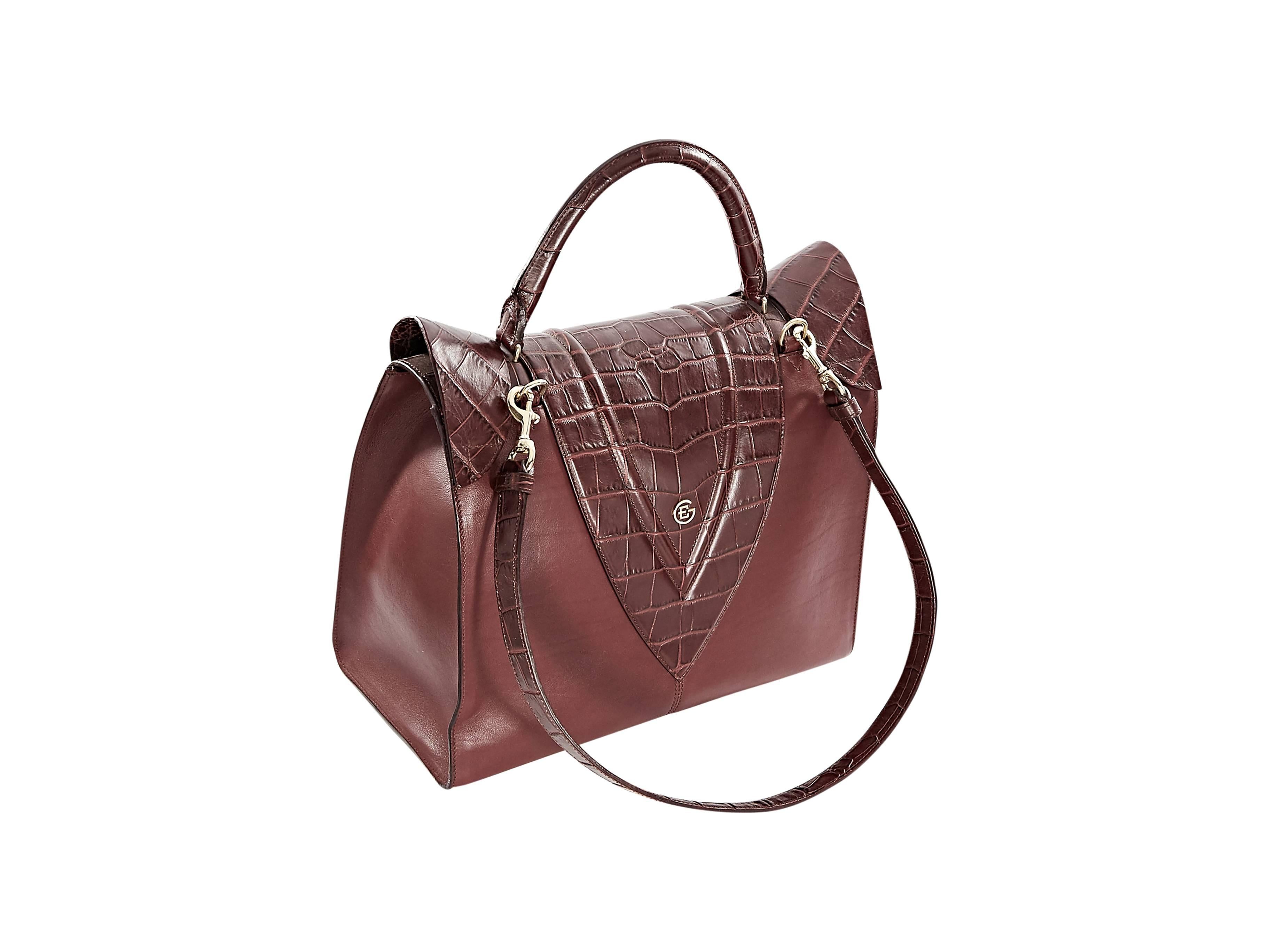 Burgundy leather satchel handbag by Elena Ghisellini.  Top handle.  Detachable crossbody strap.  Snake-embossed front flap.  Hidden closure.  Lined interior with inner pockets.  Removable zip-close pouch.  Protective metal feet.  Goldtone hardware.