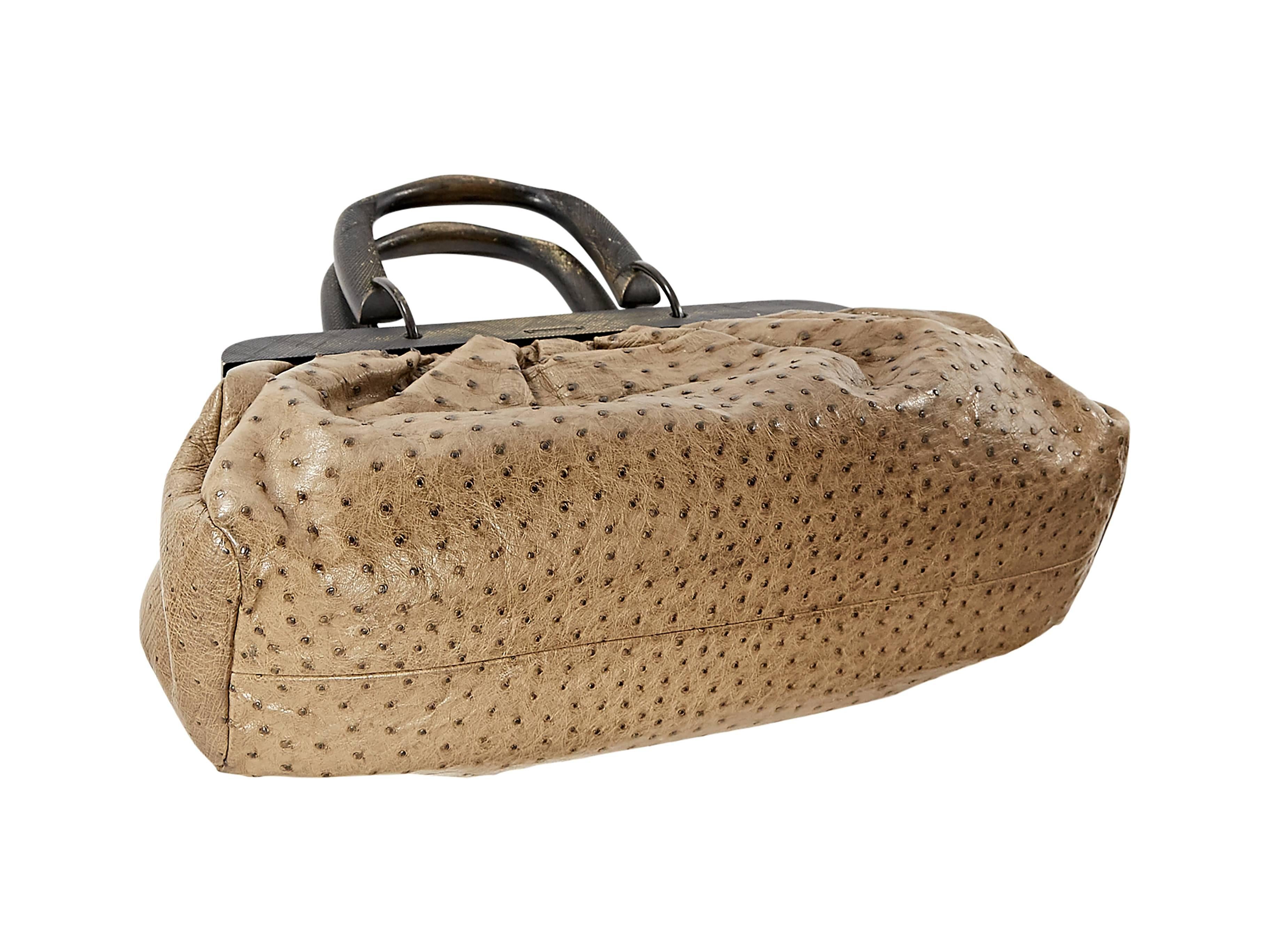 Brown ostrich top-handle bag by Gucci.  Top carry handles.  Buckle closure.  Lined interior with zip pocket.  Black hardware.  17