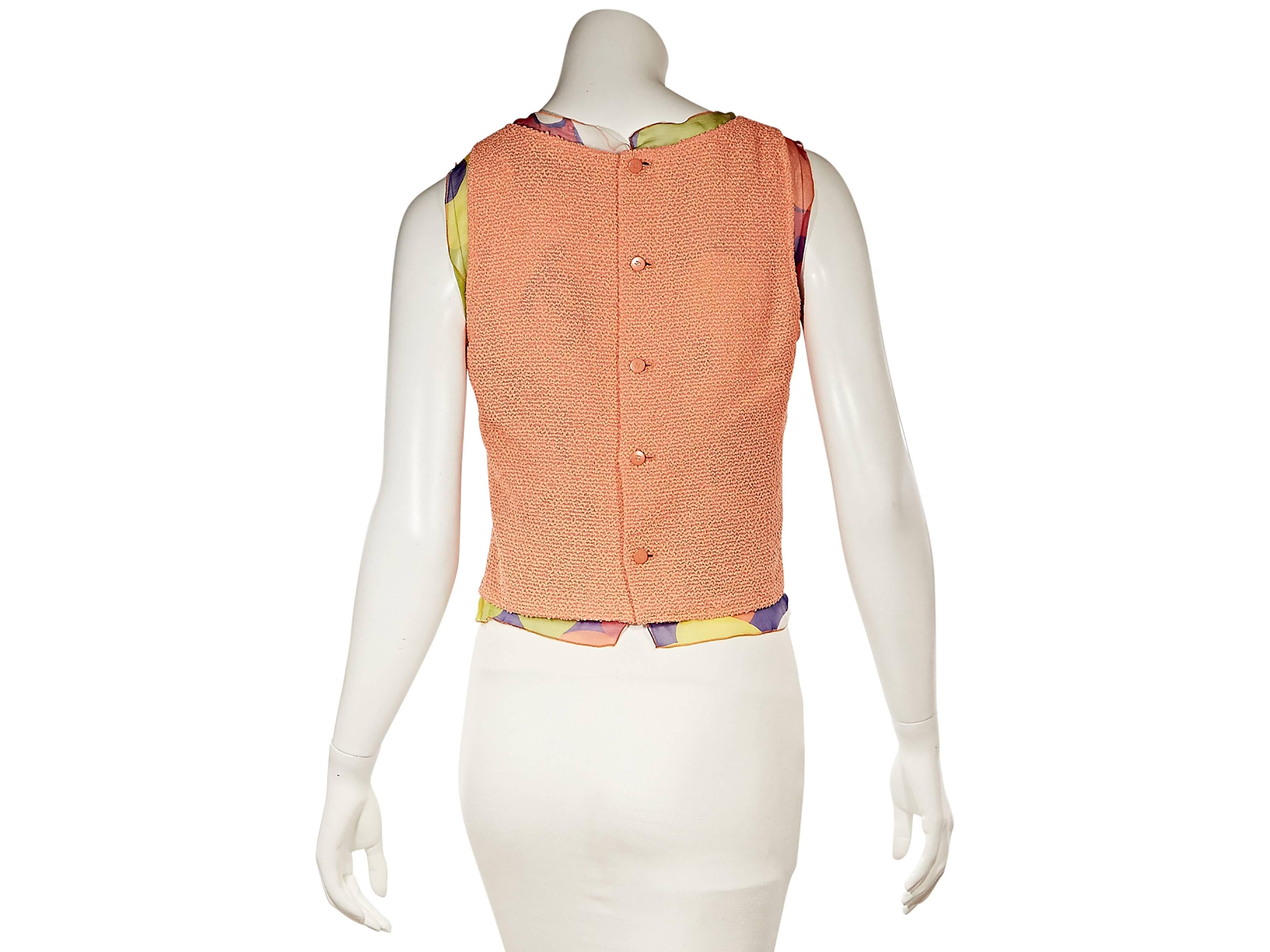Product details:  Orange shell top with printed silk trim by Chanel.  Scoopneck. Sleeveless.  Button back 
Condition: Excellent.  

