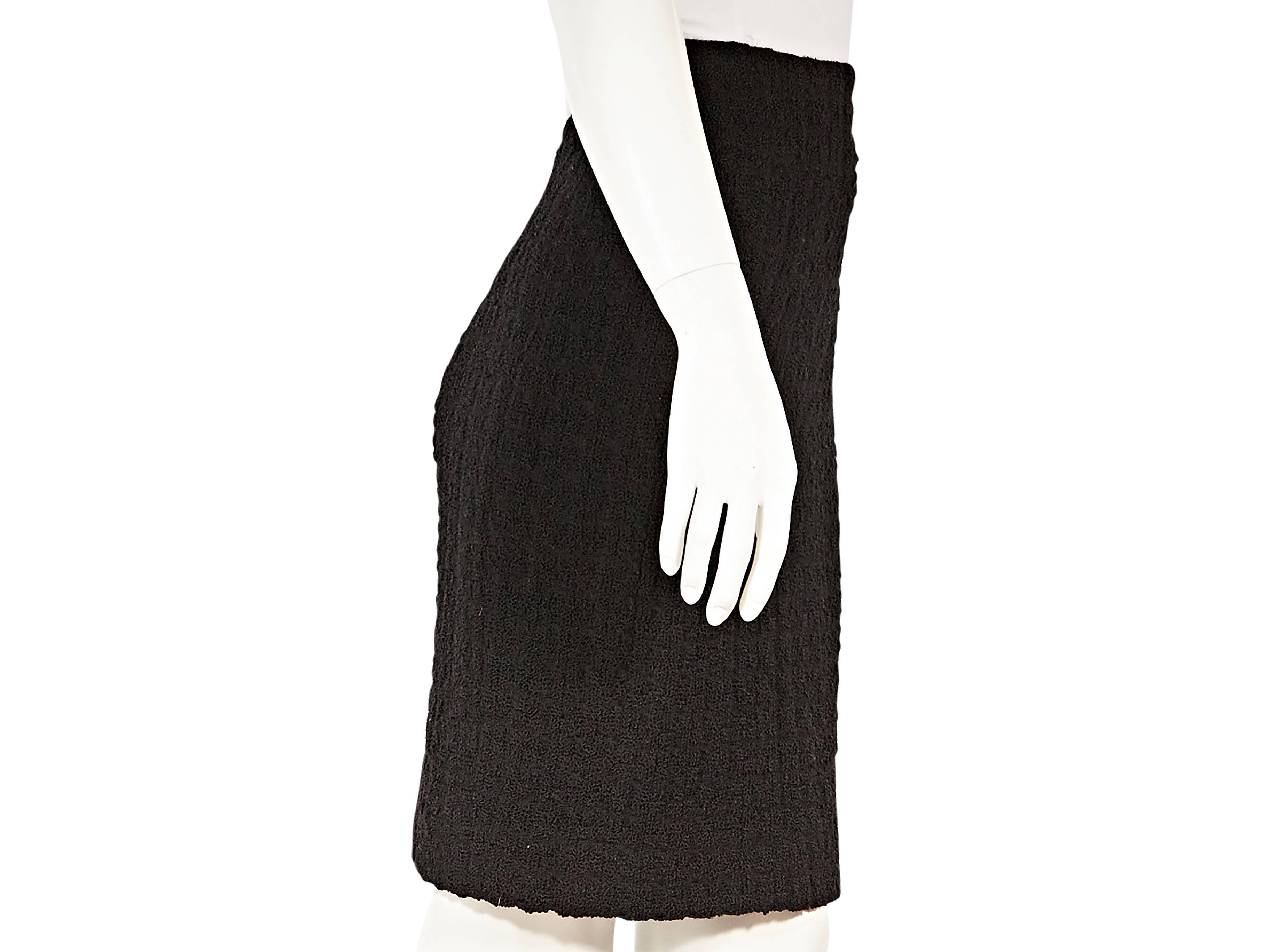 Product details:  Black wool pencil skirt by Chanel.  Wide banded waist.  Concealed back zip closure. 
Condition: Excellent.  
