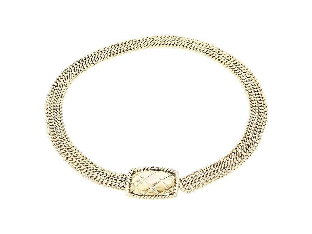 Product details:  Goldtone chain belt by Chanel.  Quilted buckle.  Concealed hook-and-eye closure.  Approximately 32