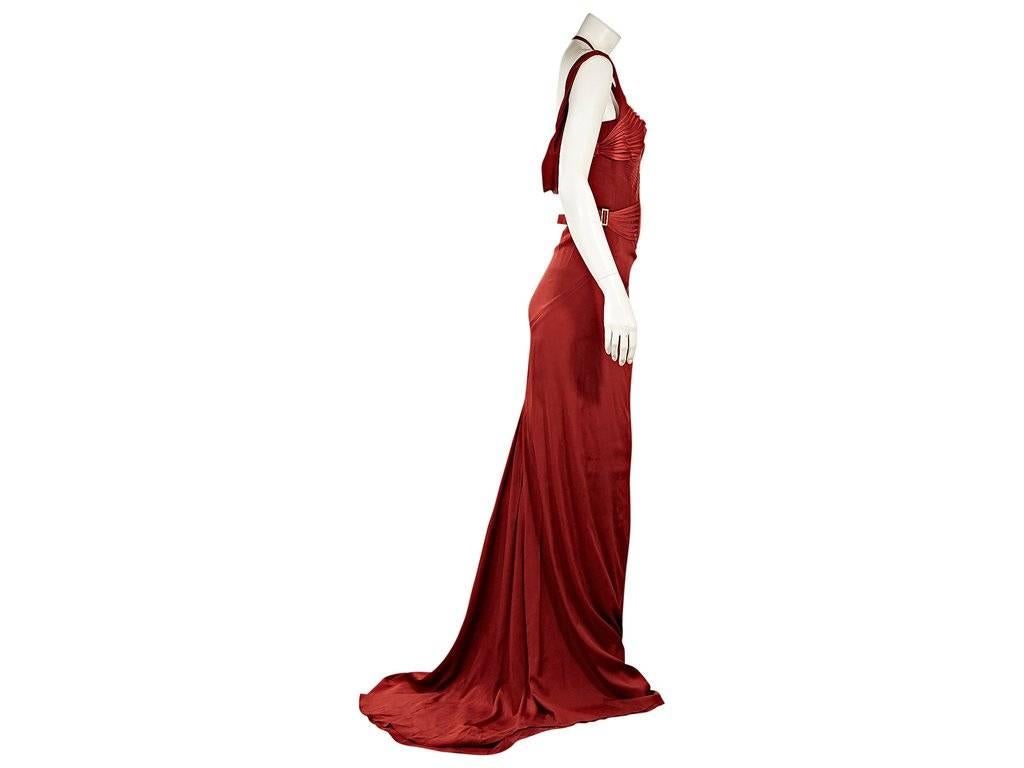 Product details:  Red silk evening gown by Gucci.  From the Tom Ford era.  Halterneck with shoulder straps.  Sexy pleated corset-like bodice.  Hook-and-eye front closure.  Open back.  
Condition: Excellent.  New with tags.  
