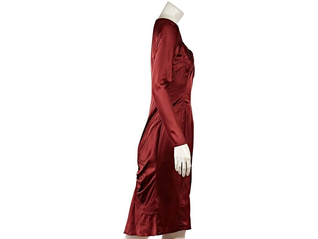 Product details:  Red silk-blend dress by Gucci.  From the Tom Ford era.  Features flattering ruched detailing.  Scoopneck.  Long sleeves.  Side waist pockets.  Concealed back zip closure.
Condition: Excellent. 