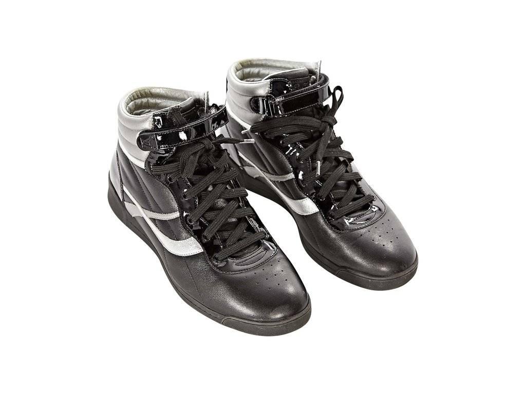 Product details:  Black and silver leather high-top sneakers by Louis Vuitton.  Velcro strap with lace-up closure.  Trimmed with patent leather.  Round toe. 
Condition: Excellent.  