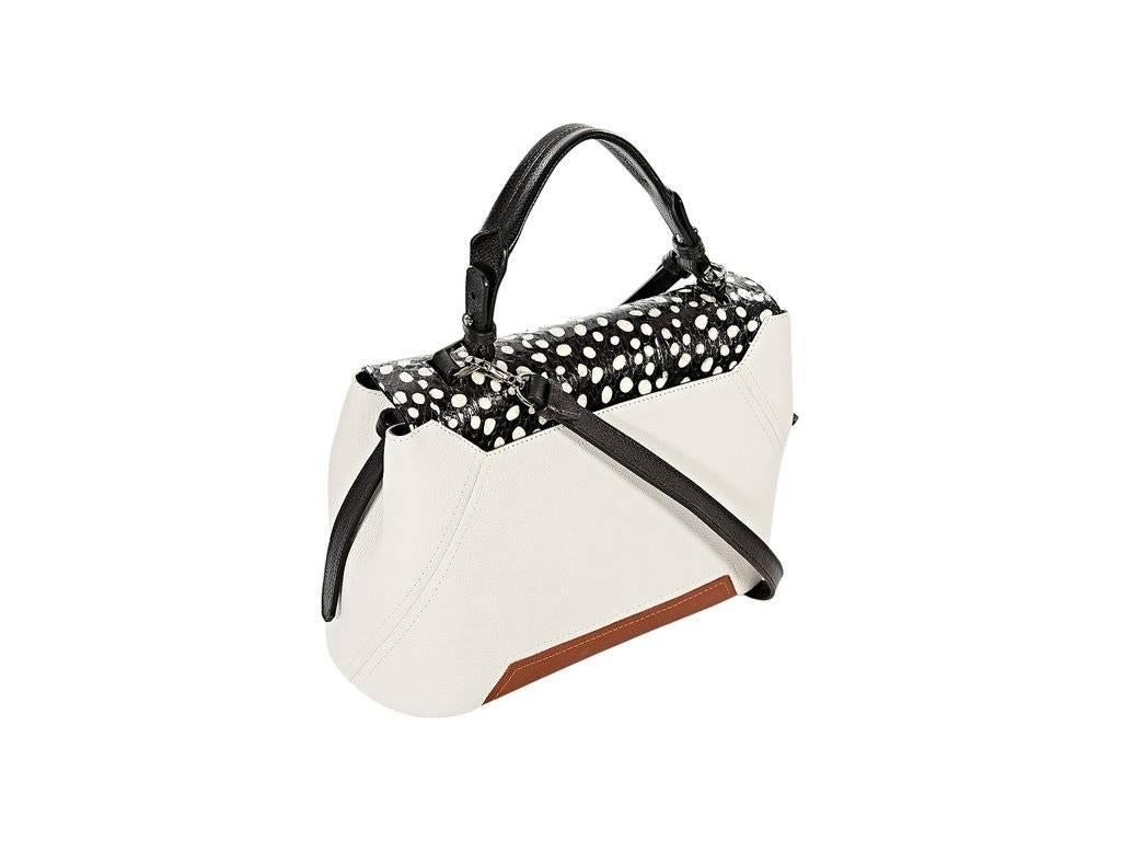 Product details:  White and tan leather satchel by Adriana Castro.  Black and white watersnake top flap.  Top carry handle.  Detachable crossbody strap.  Lined interior with inner zip pocket.  12.5