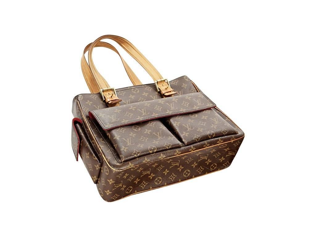 Product details:  Brown monogram canvas Multipli Cite tote bag by Louis Vuitton.  Adjustable shoulder straps.  Top zip closure.  Dual front pockets with flap closure.  Lined interior with slide pockets.  16