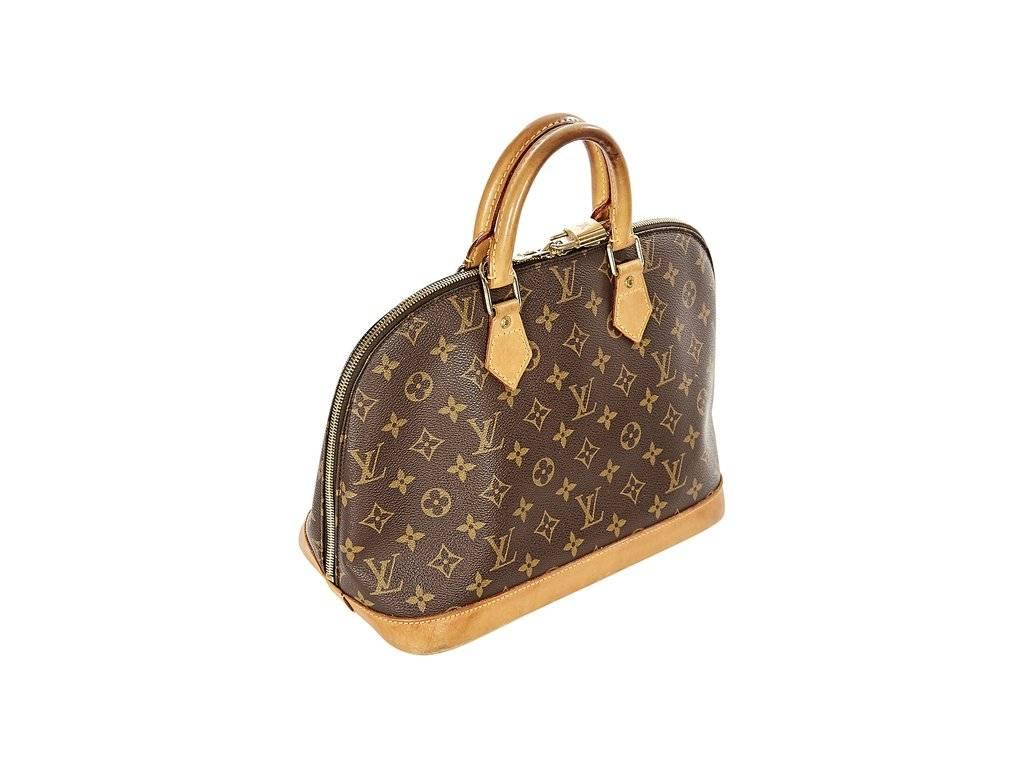 Product details:  Alma PM monogram canvas handbag by Louis Vuitton.  Top carry handles.  Double top zip closure with lock and key.  Lined interior with inner pockets.  12.6