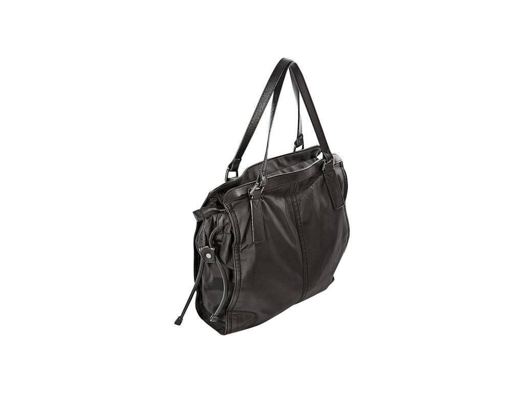 Product details:  Black nylon tote bag by Burberry.  Dual leather shoulder straps.  Top zip closure.  Drawstring sides.  Lined interior with inner zip pocket.  Silvertone hardware.  12