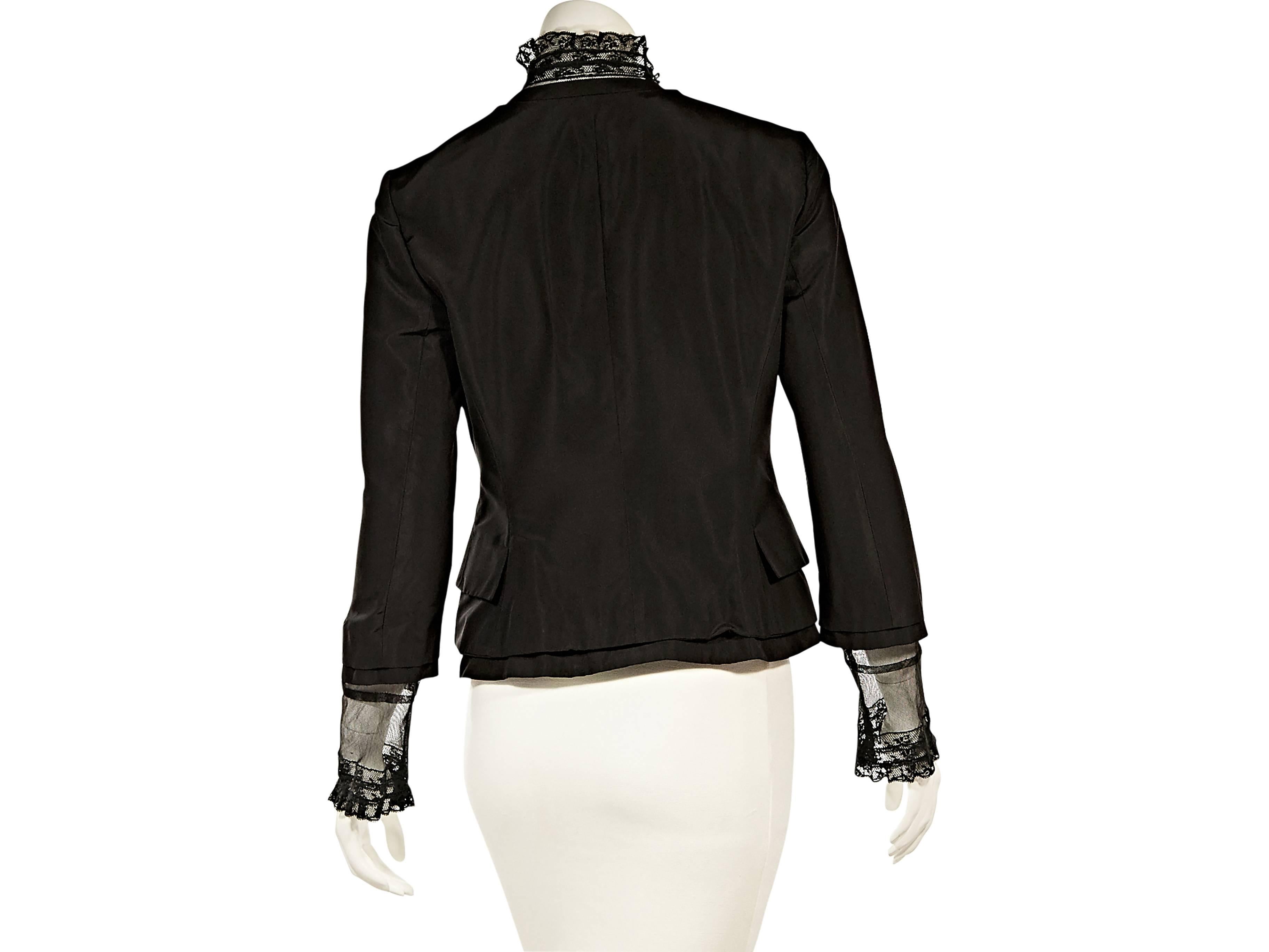 Product details:  Black Victorian-inspired jacket by Alexander McQueen.  Mock neck.  Long sleeves with lace cuffs.  Front tab closure.  Lace front with button closure.  Waist flap pockets.   
Condition: Excellent.  
