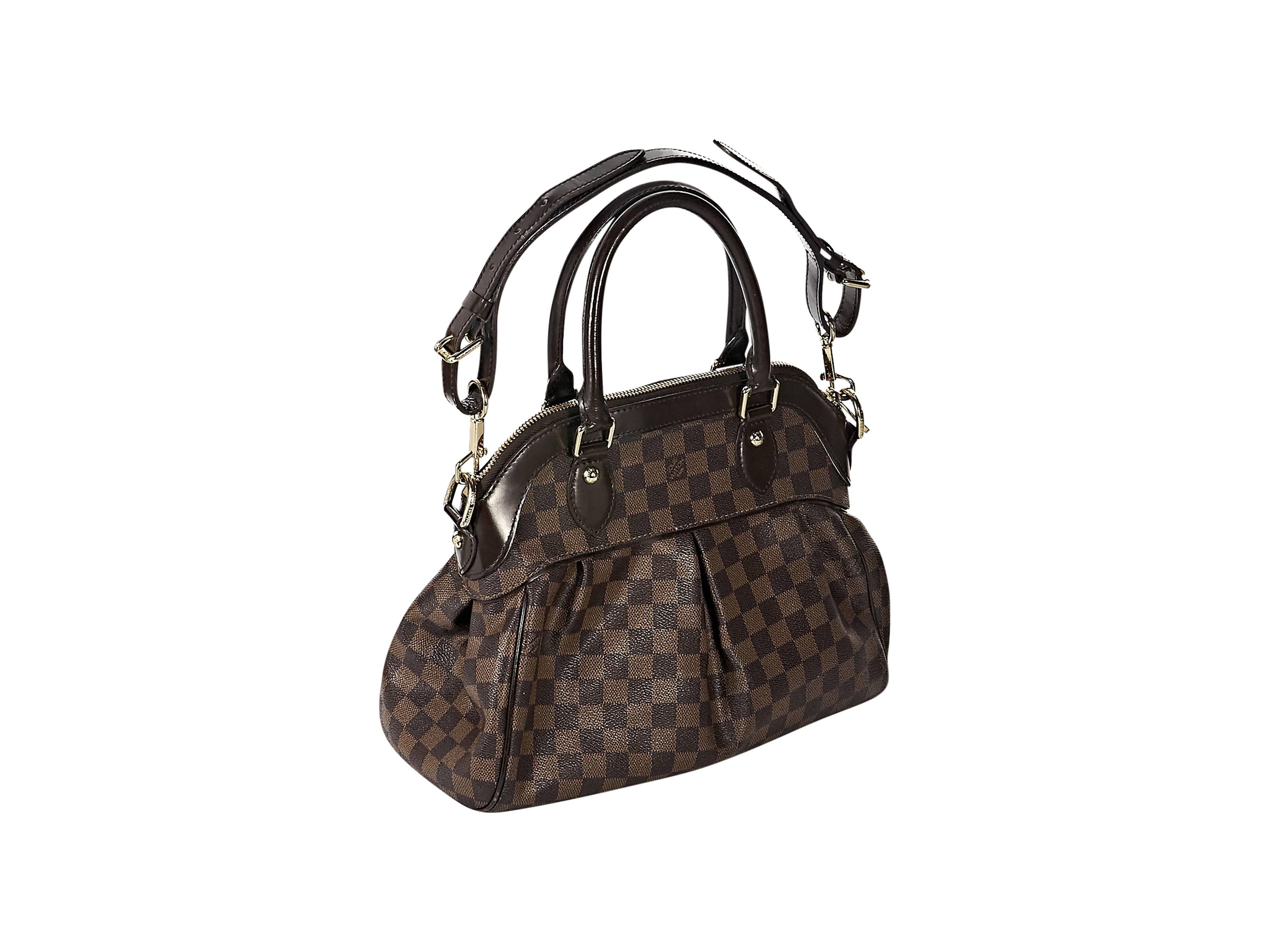 Product details: Brown damier ebene canvas Trevi PM satchel by Louis Vuitton. Dual top carry handles. Removable, adjustable shoulder strap. Top zip closure. Lined interior with inner pockets. Protective metal feet. Goldtone hardware. 
Condition: