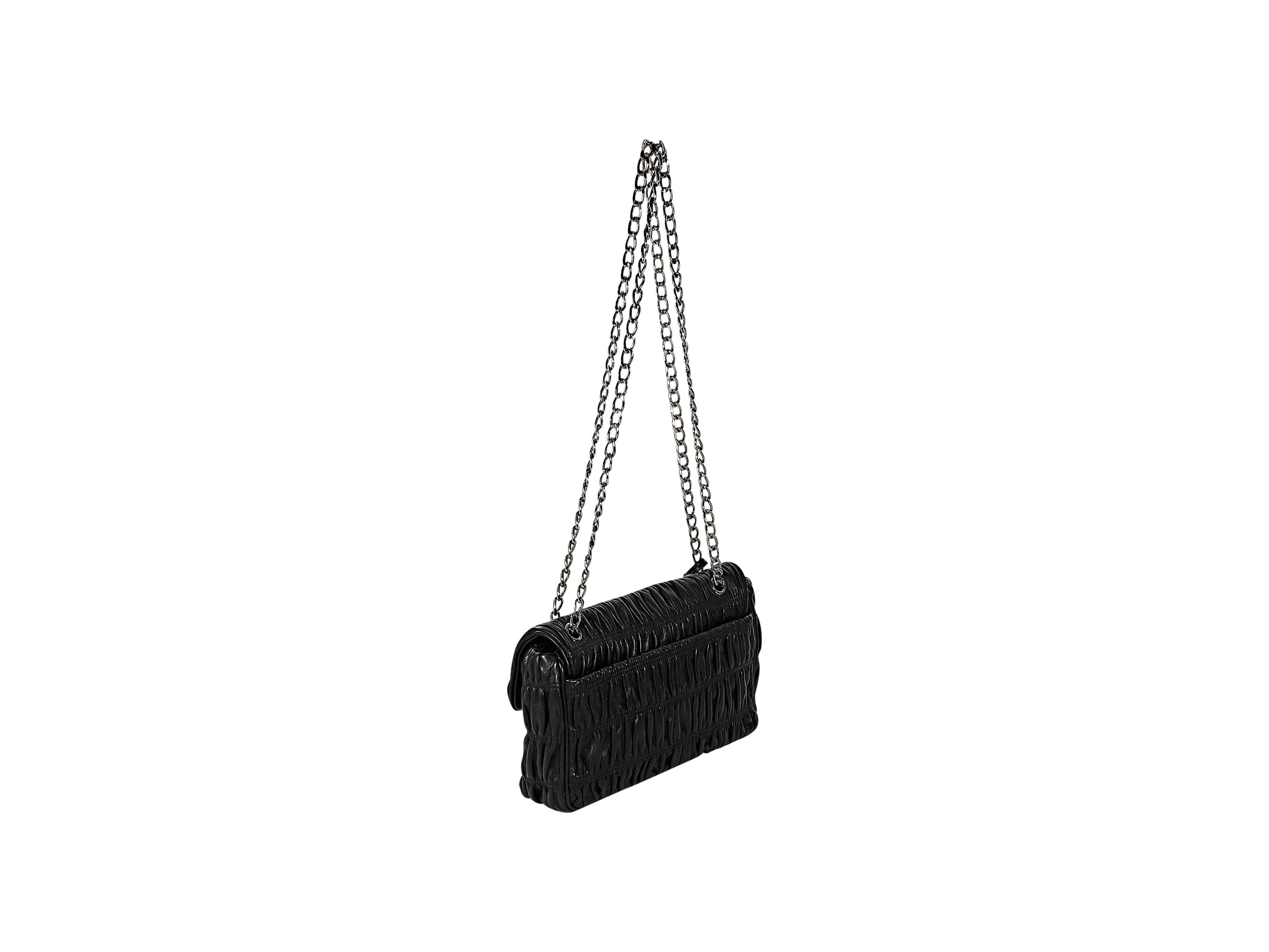 Product details: Black leather nappa gaufre gathered bag by Prada. Chain shoulder strap. Push lock and key closure. Lined interior with inner zip and slide pockets. Silvertone hardware. 12