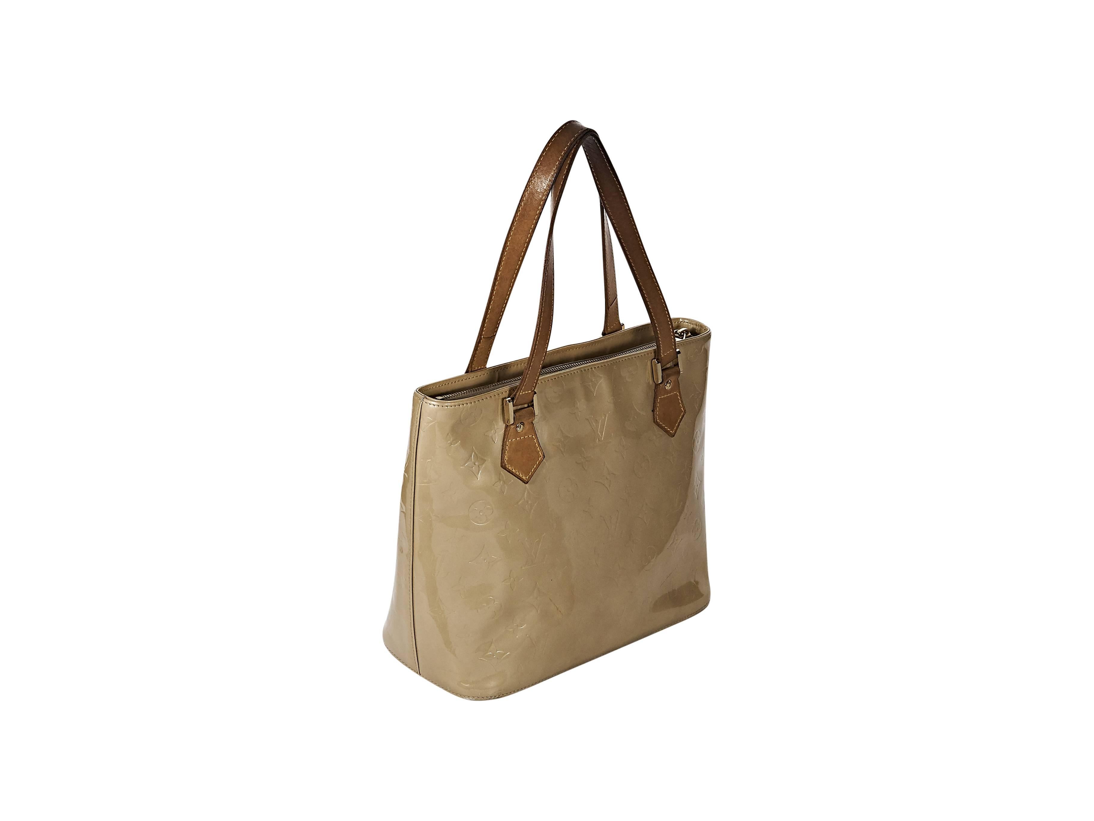 Product details: Beige monogram vernis Houston tote bag by Louis Vuitton. Dual leather shoulder straps. Top zip closure. Leather lined interior with inner zip pocket. Flat bottom. Dust bag included. 11