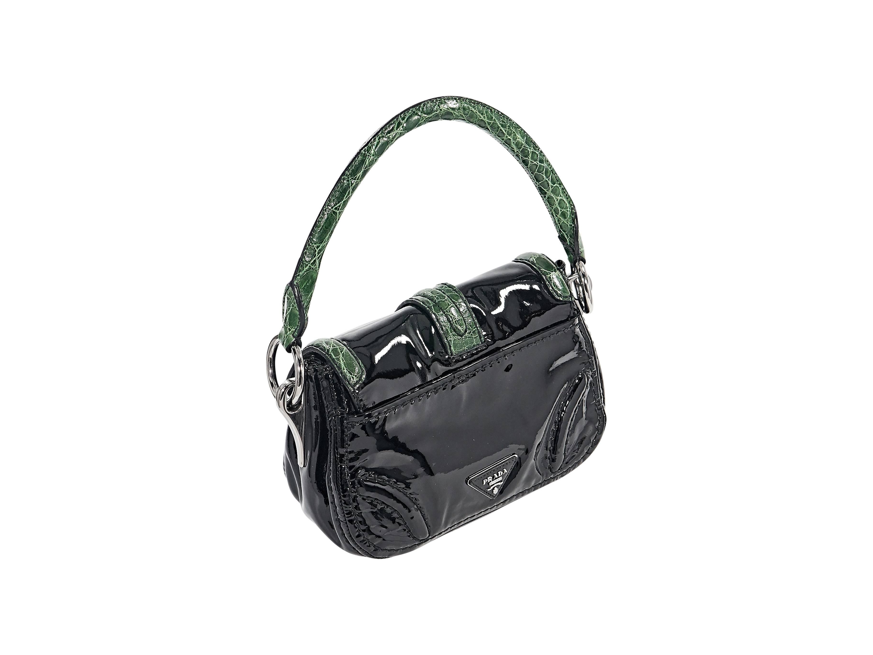 Product details:  Black patent leather hobo handbag by Prada.  Trimmed with green crocodile skin. Single shoulder strap.  Front flap with twist-lock closure.  Lined interior with inner zip and slide pockets.  Protective metal feet.  Silvertone