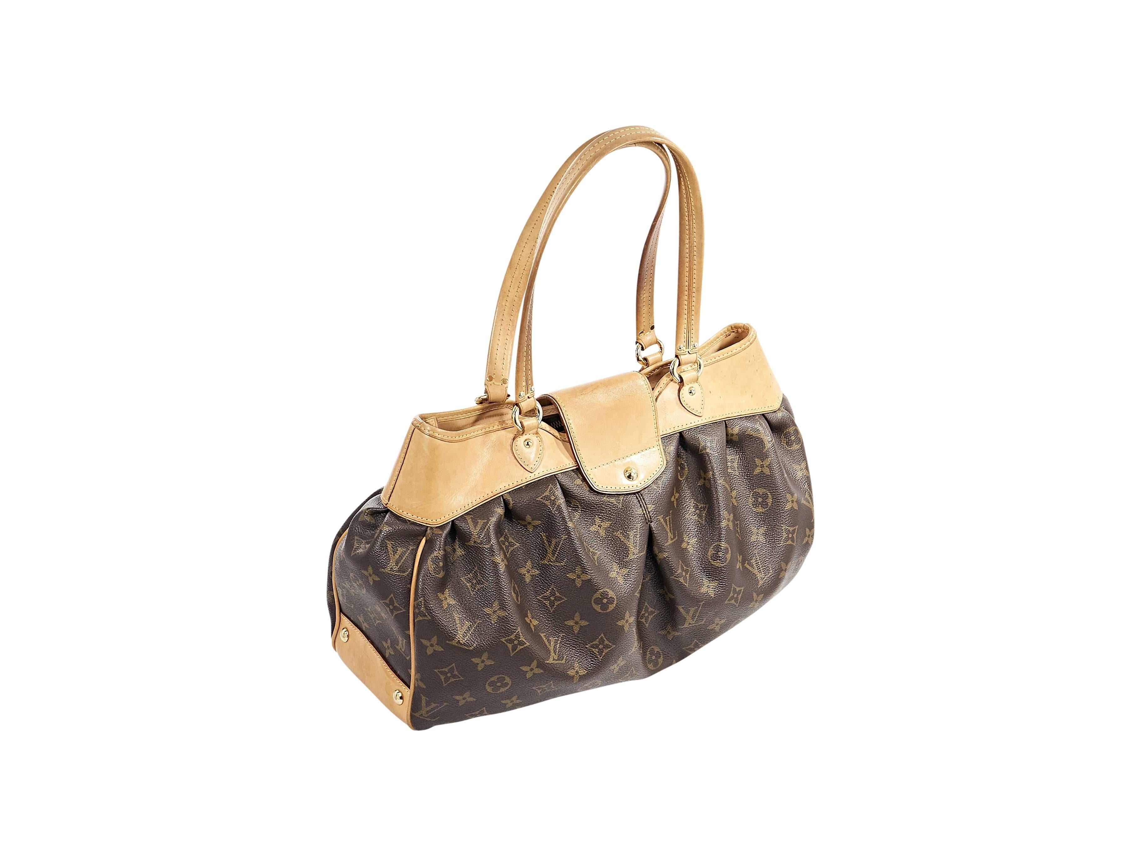 Product details:  Brown monogram canvas Bowtie PM bag by Louis Vuitton.  Trimmed with tan leather.  Dual shoulder straps.  Twist-lock strap over top zip closure.  Lined interior with inner slide pockets.  Protective metal feet.  Goldtone hardware. 