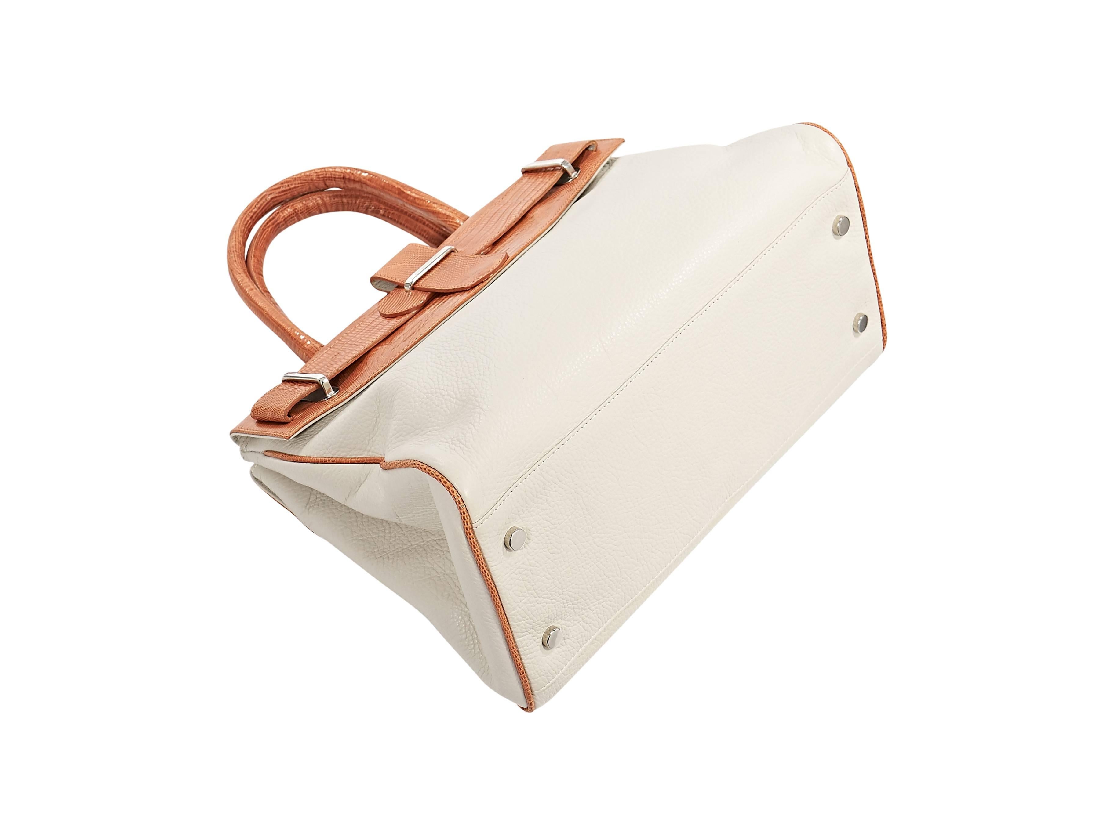 Product details:  ﻿White leather structured tote bag by Daniella Ortiz.  Trimmed with exotic orange lizard skin.  Dual carry handles.  Outer flap pockets.  Magnetic snap closure.  Lined interior with two inner compartments and zip pocket. Protective