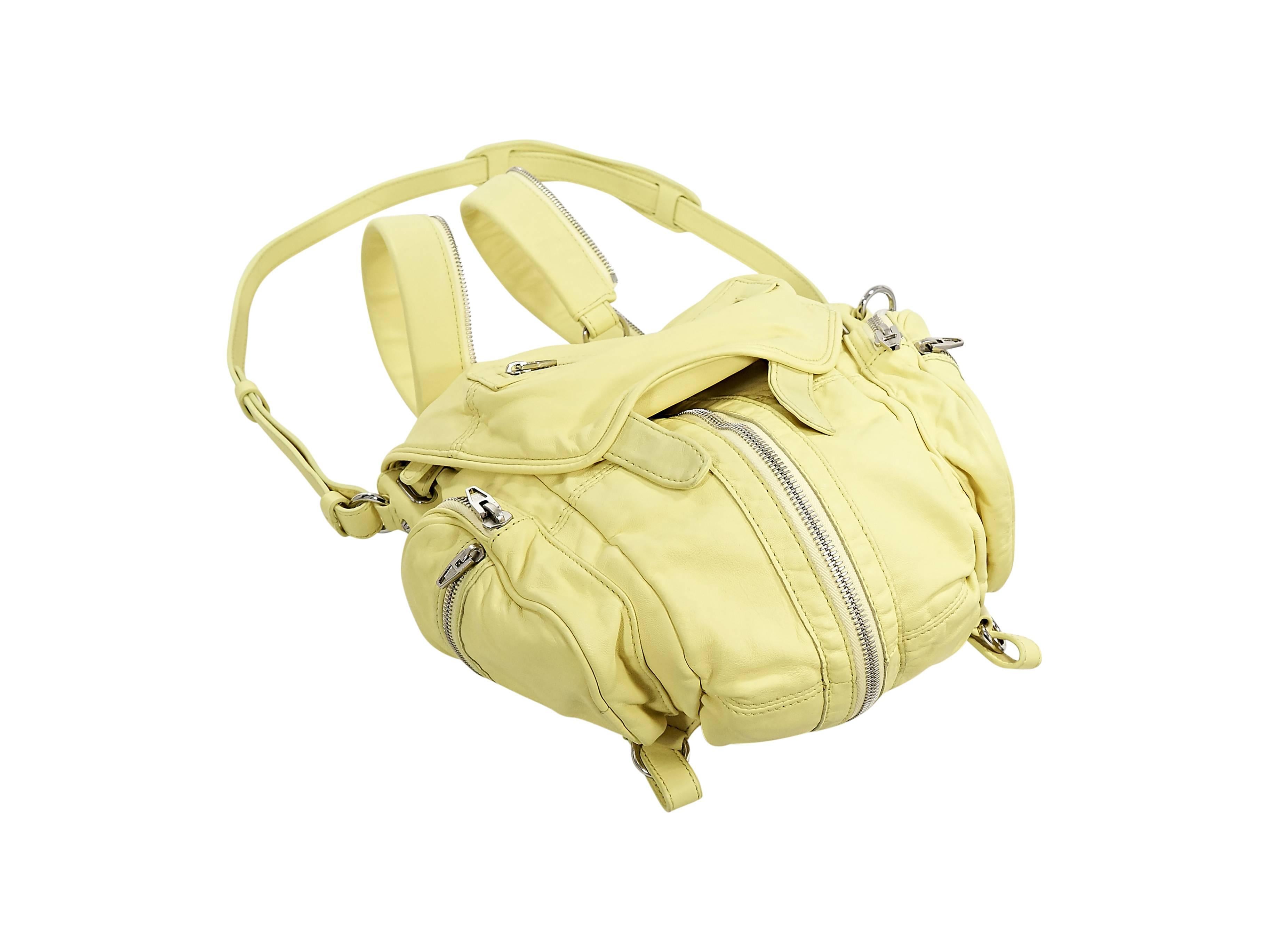 Product details:  Yellow leather Marti convertible backpack by Alexander Wang.  Zip-apart shoulder straps or carry handles.  Optional, detachable crossbody strap.  Front flap with zip pocket.  Expandable front zip gusset.  Side double zip pockets. 