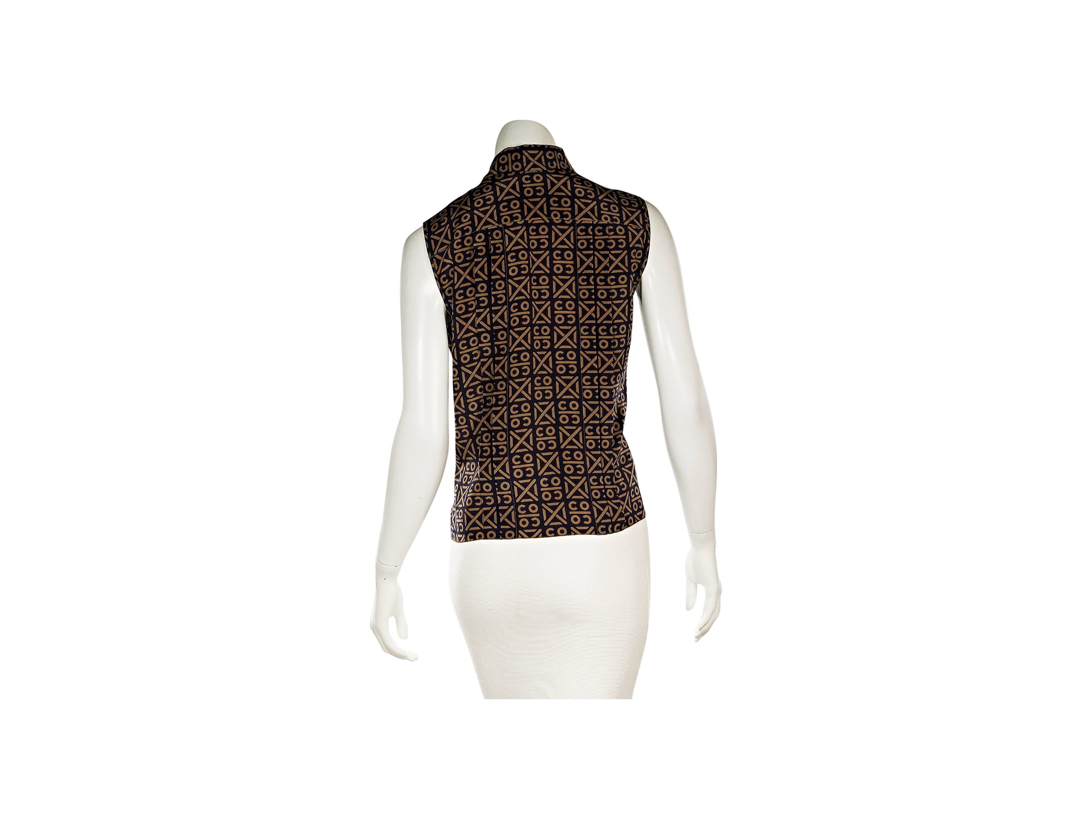 Product details:  Brown printed silk blouse by Chanel.  Front and back pleats.  Sleeveless.  Point collar.  Concealed closure.  
Condition: Excellent. 