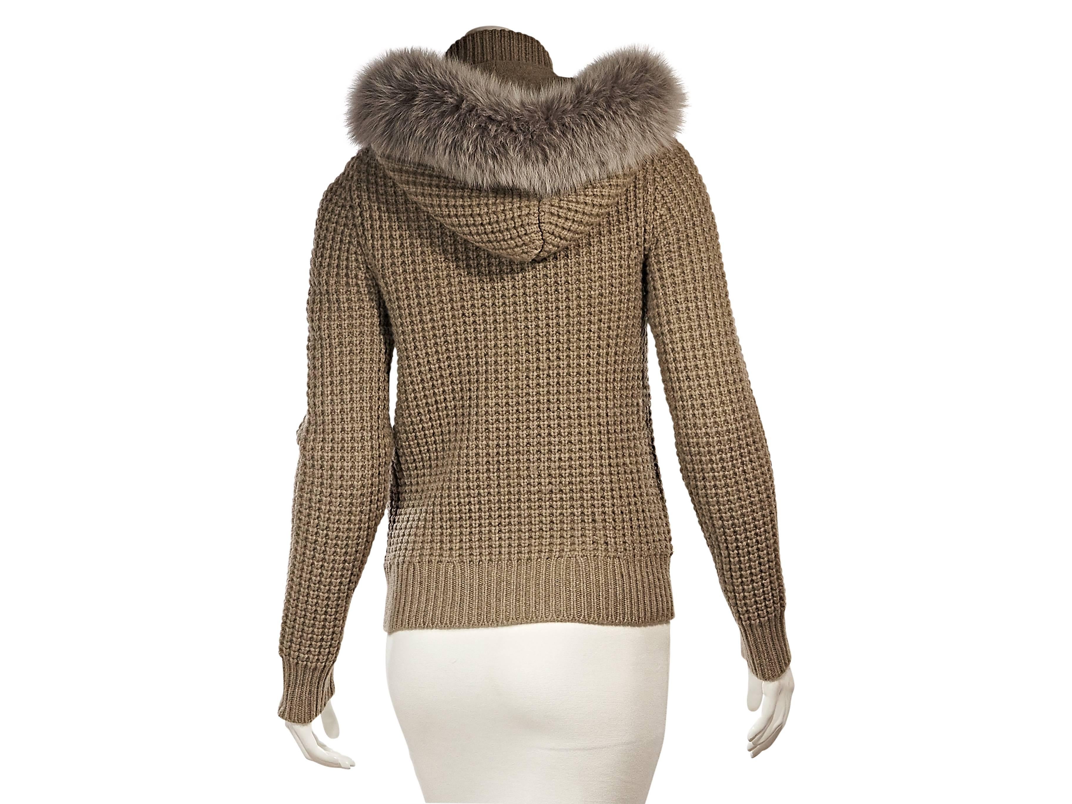 Product details: Tan cashmere sweater jacket by Michael Kors. Attached hood trimmed with dyed fox fur. Stand collar. Long sleeves. Zip-front closure. Two front zip pockets. 
Condition: Excellent. 
Retails: $2150