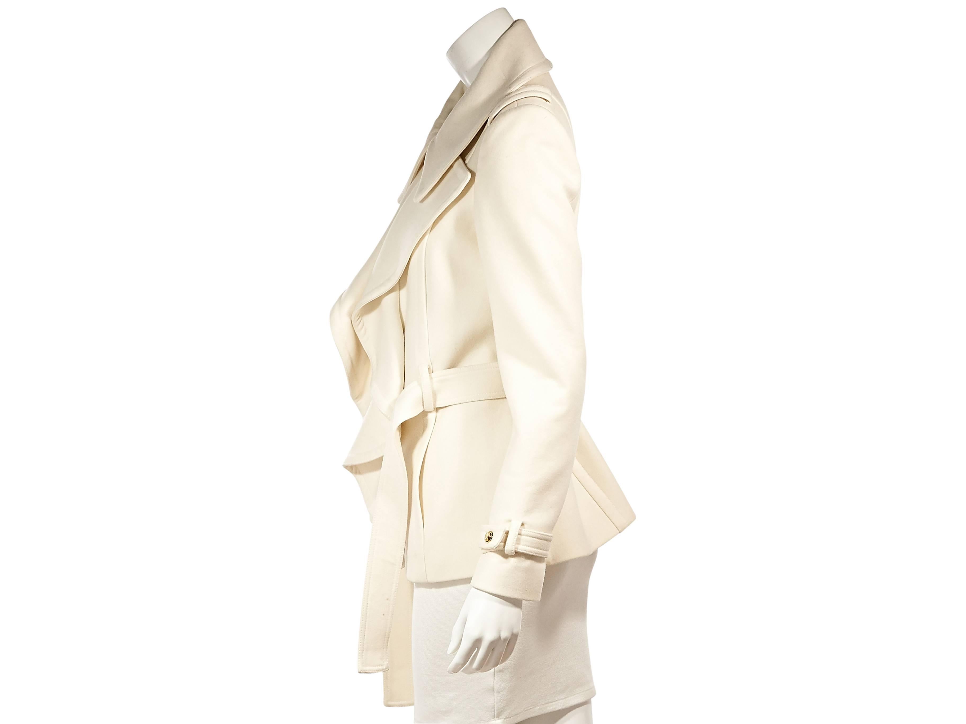 Product details:  ﻿Ivory wool and cashmere ruffle-front jacket by Roberto Cavalli.  Exaggerated spread collar and lapel.  Long sleeves.  Button-front closure.  Tie belted waist. 
Condition: Excellent. 
Retails: $995.00