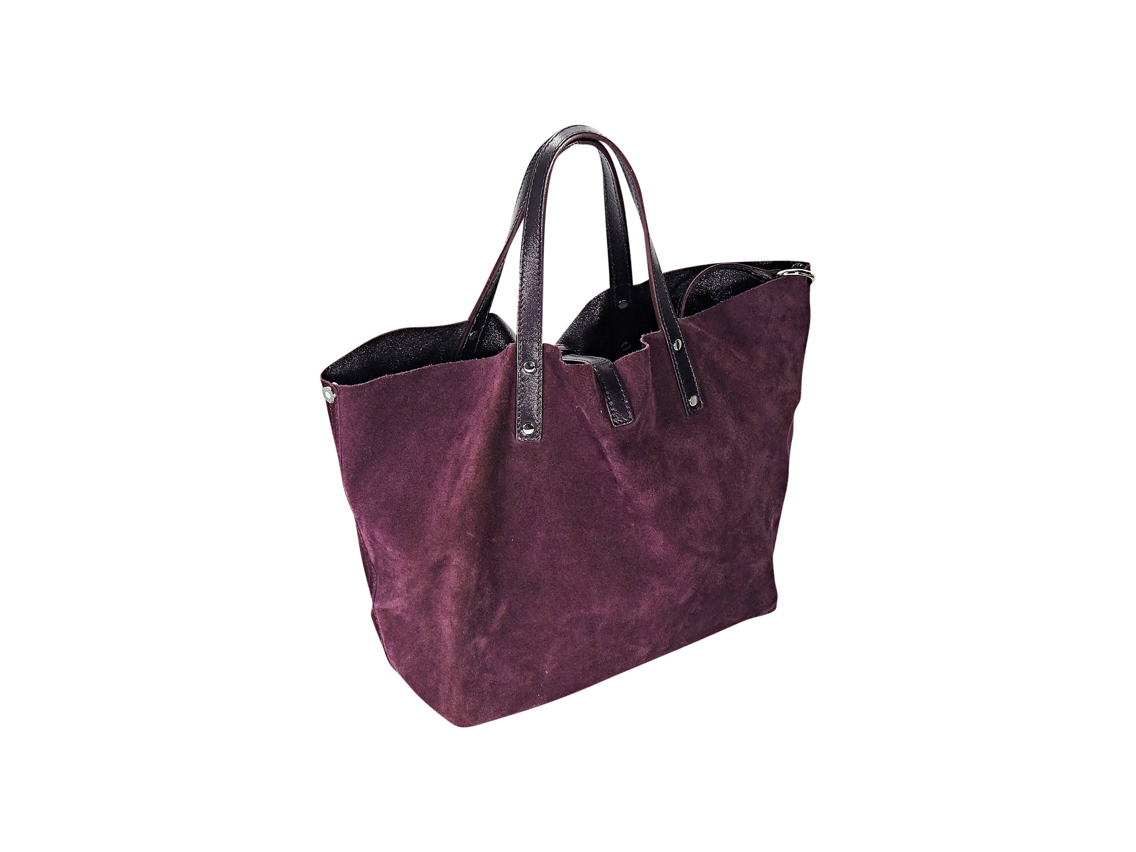 Product details: Burgundy suede and leather reversible tote bag by Tiffany & Co. Dual shoulder straps. Top bridge strap. Interior clasp strap. Protective metal feet. Goldtone hardware. 10
