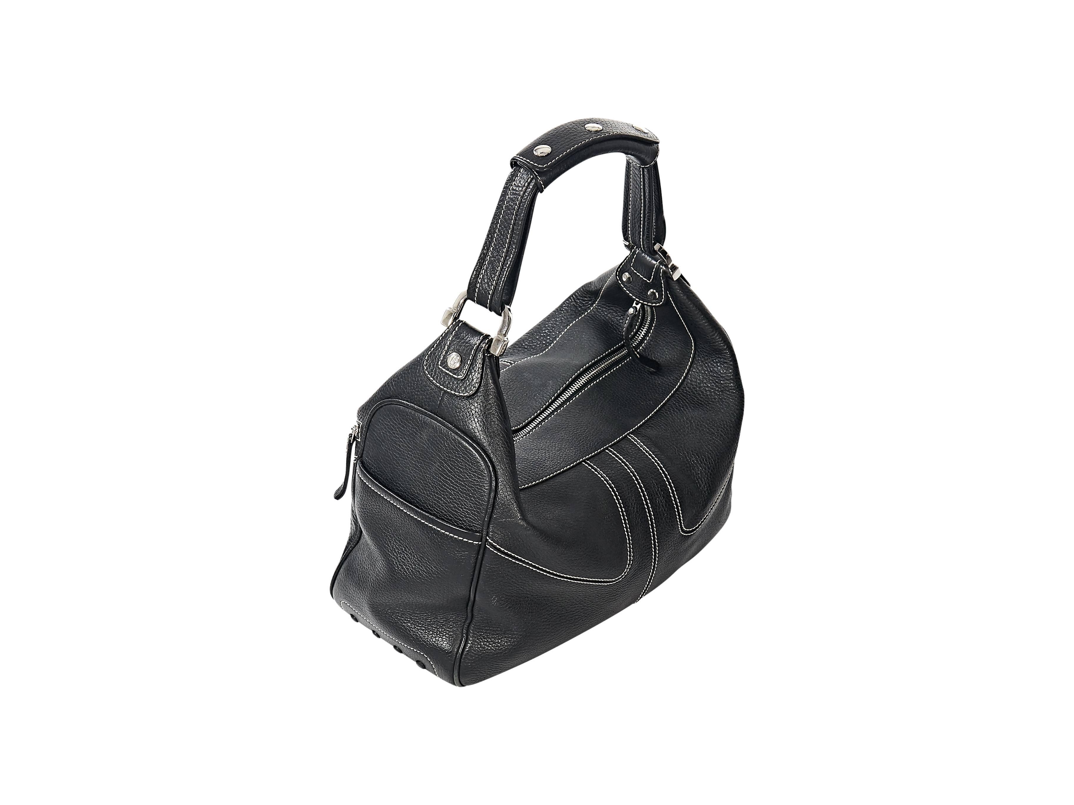Product details: Black leather Miky hobo bag by Tod's. Accented with white topstitching. Single shoulder strap. Top zip closure. Front zip pockets. Lined interior with inner zip pocket. Protective rubber feet at corners. Silvertone hardware.