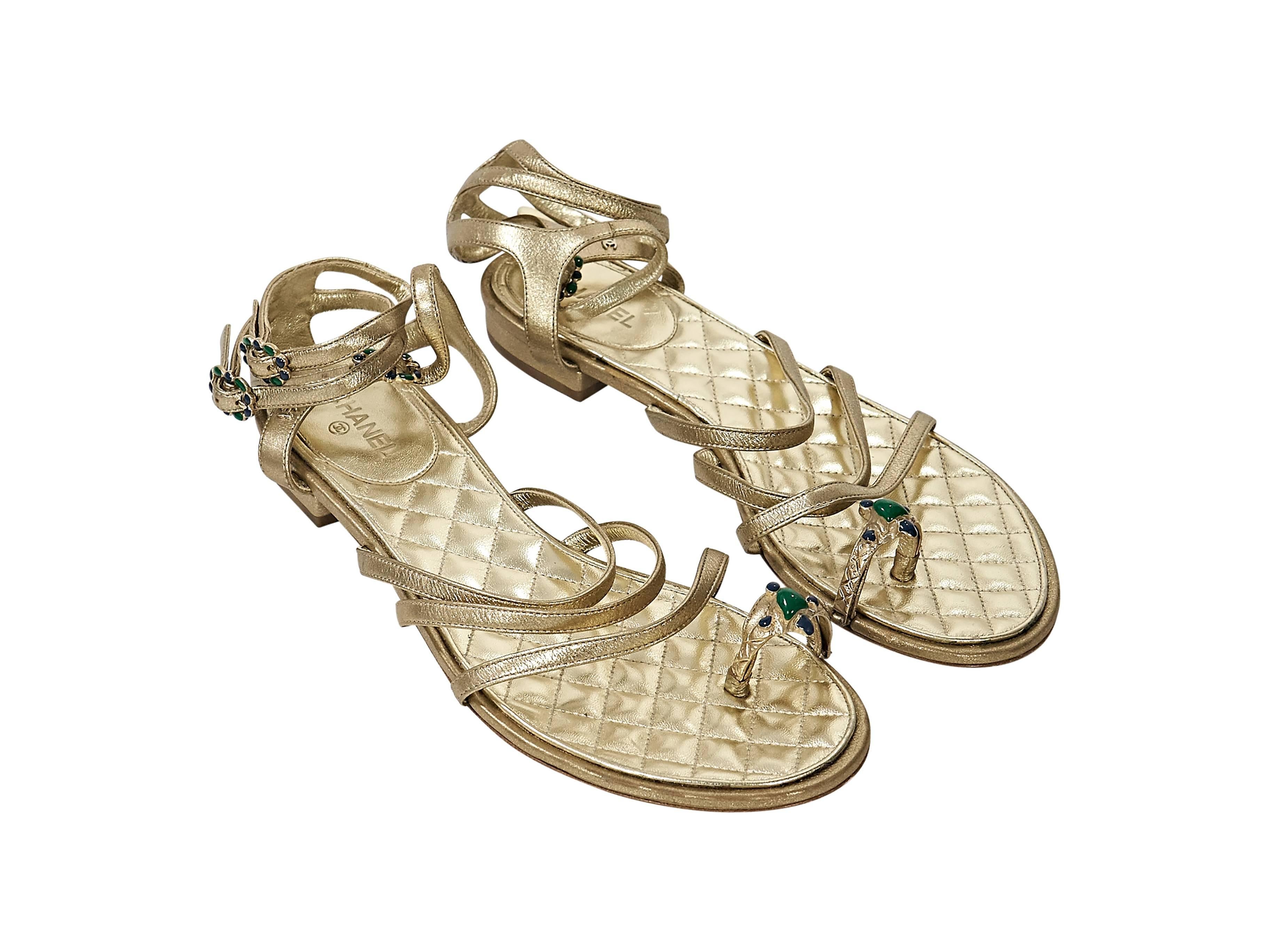 Product details: Gold leather strappy flat sandals by Chanel. Triple adjustable ankle straps. Embellished toe ring. Quilted leather lining.
Condition: Very good. 