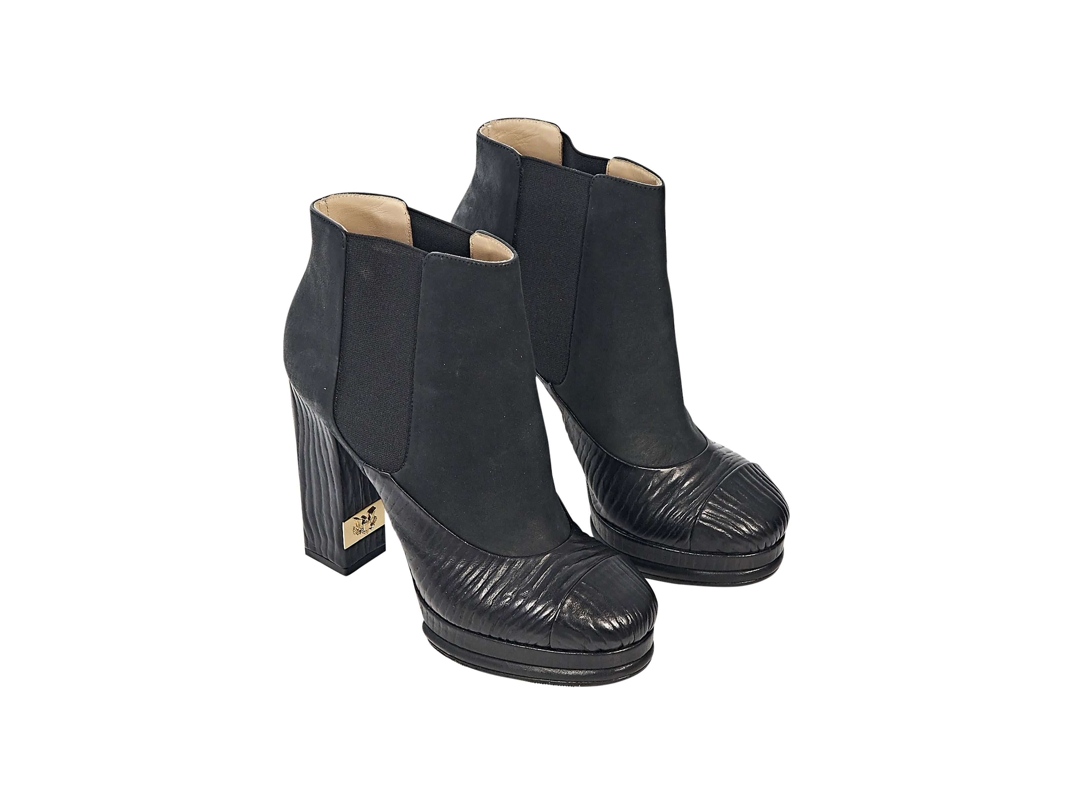 Product details:  Black textured heeled Chelsea boots by Chanel.  Elasticized side panels for an easy fit.  Round cap toe.  Platform and towering heel.  Slip-on style.  Goldtone hardware. 
Condition: Excellent. 