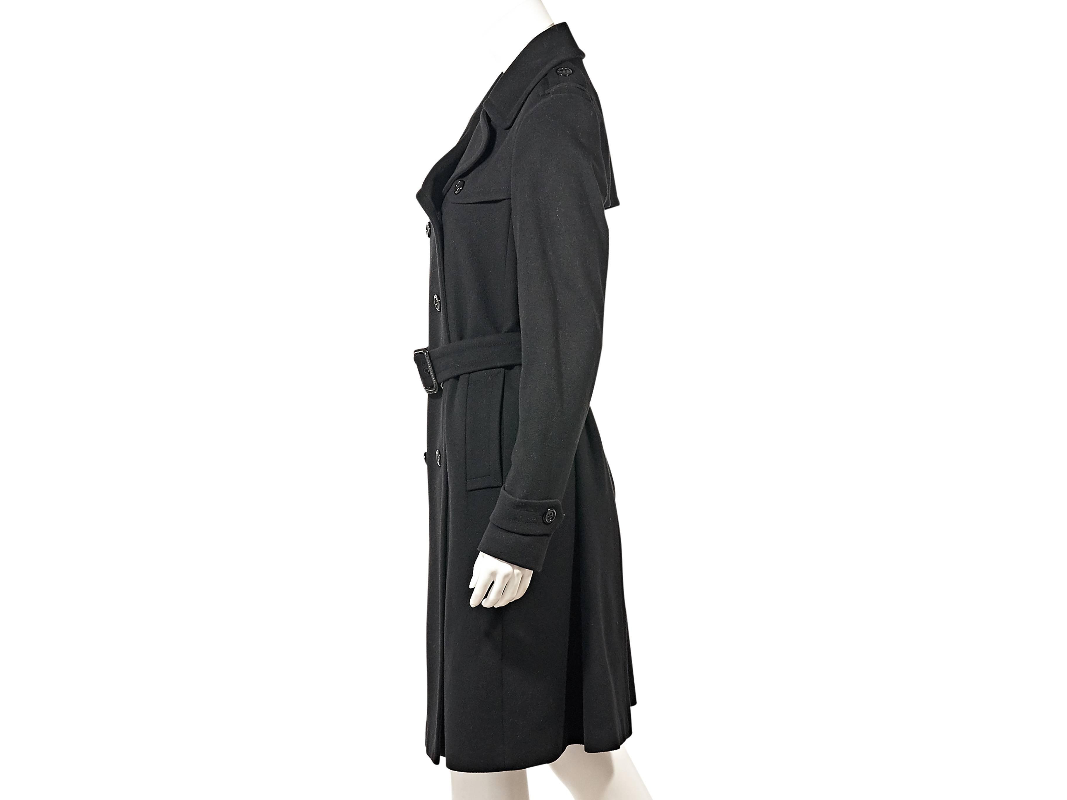 Product details:  ﻿Black wool trench coat by Burberry.  Notched lapel.  Long sleeves.  Adjustable button strap cuffs.  Double-breasted button-front closure.  Adjustable belted waist.  Front slide pockets.  Back storm vent.  Back hem vent.