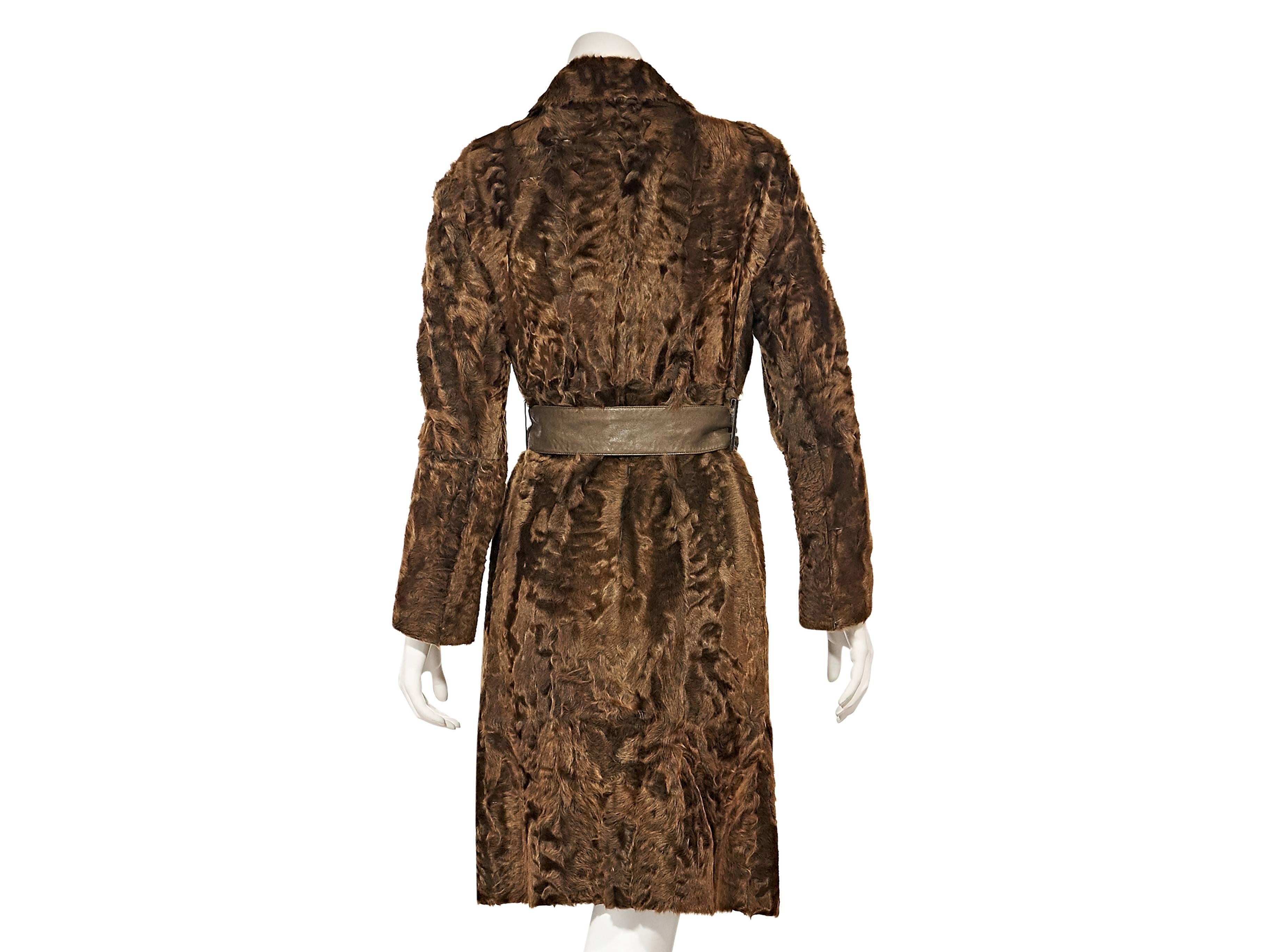 Product details:  ﻿Brown sheared goat fur coat by Akris.  Notched lapel.  Long sleeves.  Concealed front closure.  Leather self-tie belted waist.  
Condition: Excellent. 
Retails: $9998.00