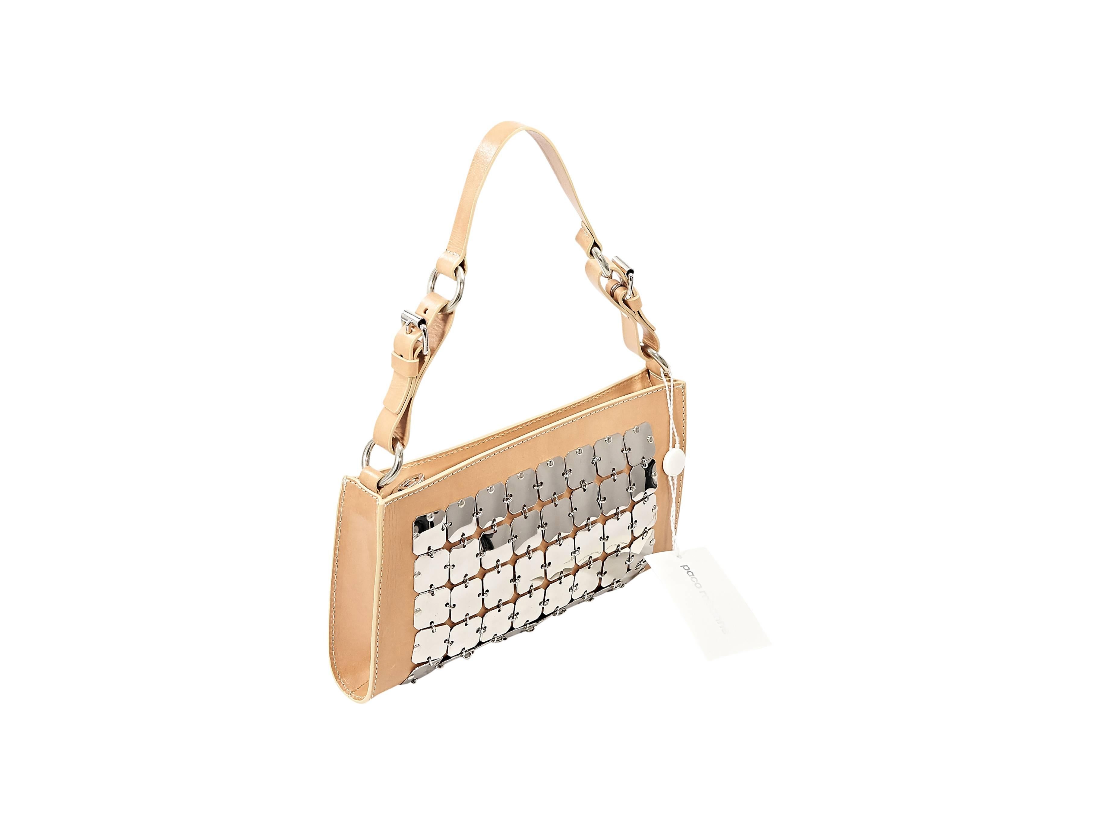 Product details:  Tan leather shoulder bag by Paco Rabanne.  Embellished with hardware accents.  Shoulder strap.  Top zip closure.  Silvertone hardware.  9.75